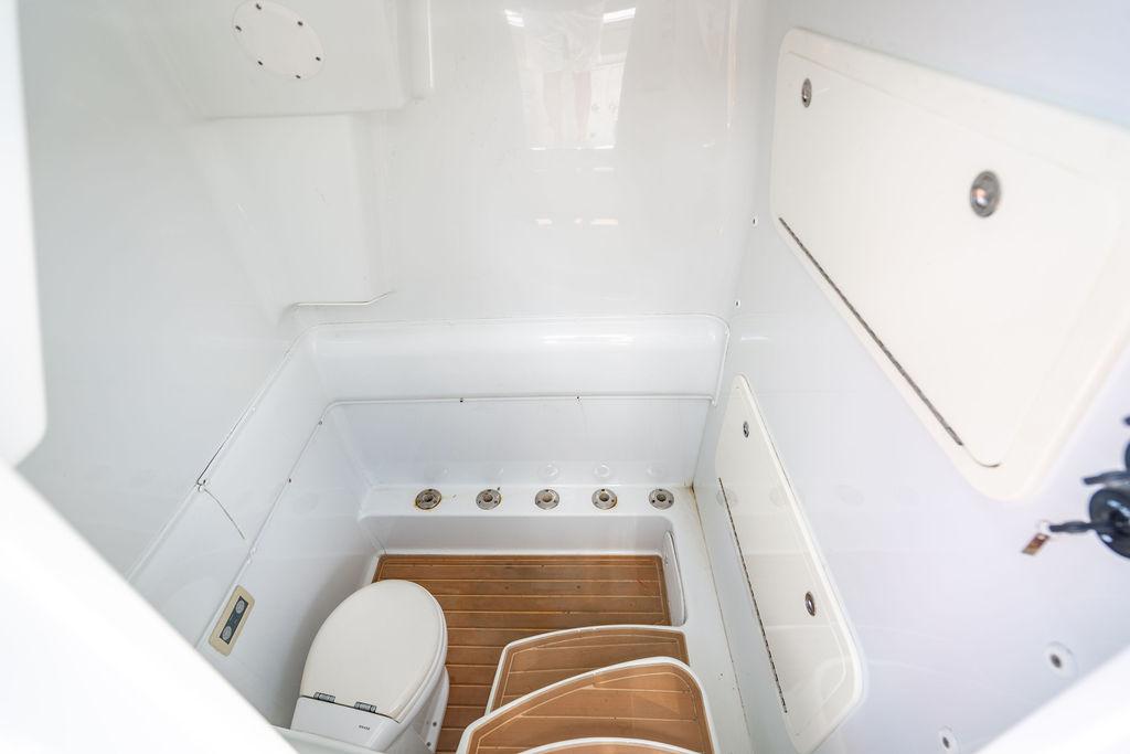 2015 Yellowfin CC boat interior with toilet and wooden flooring.