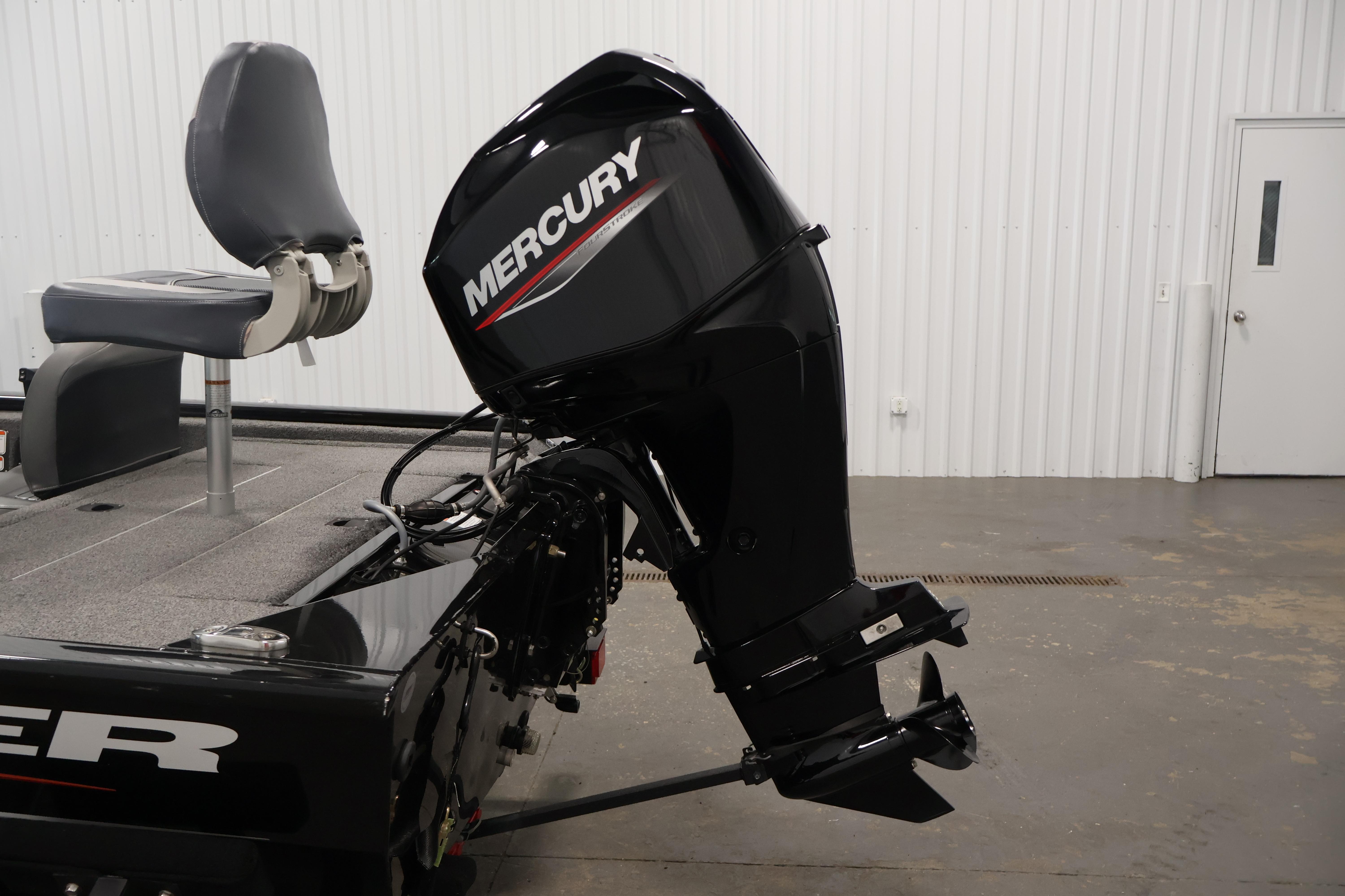 2024 Tracker Pro 170 boat with Mercury outboard motor in a garage setting.