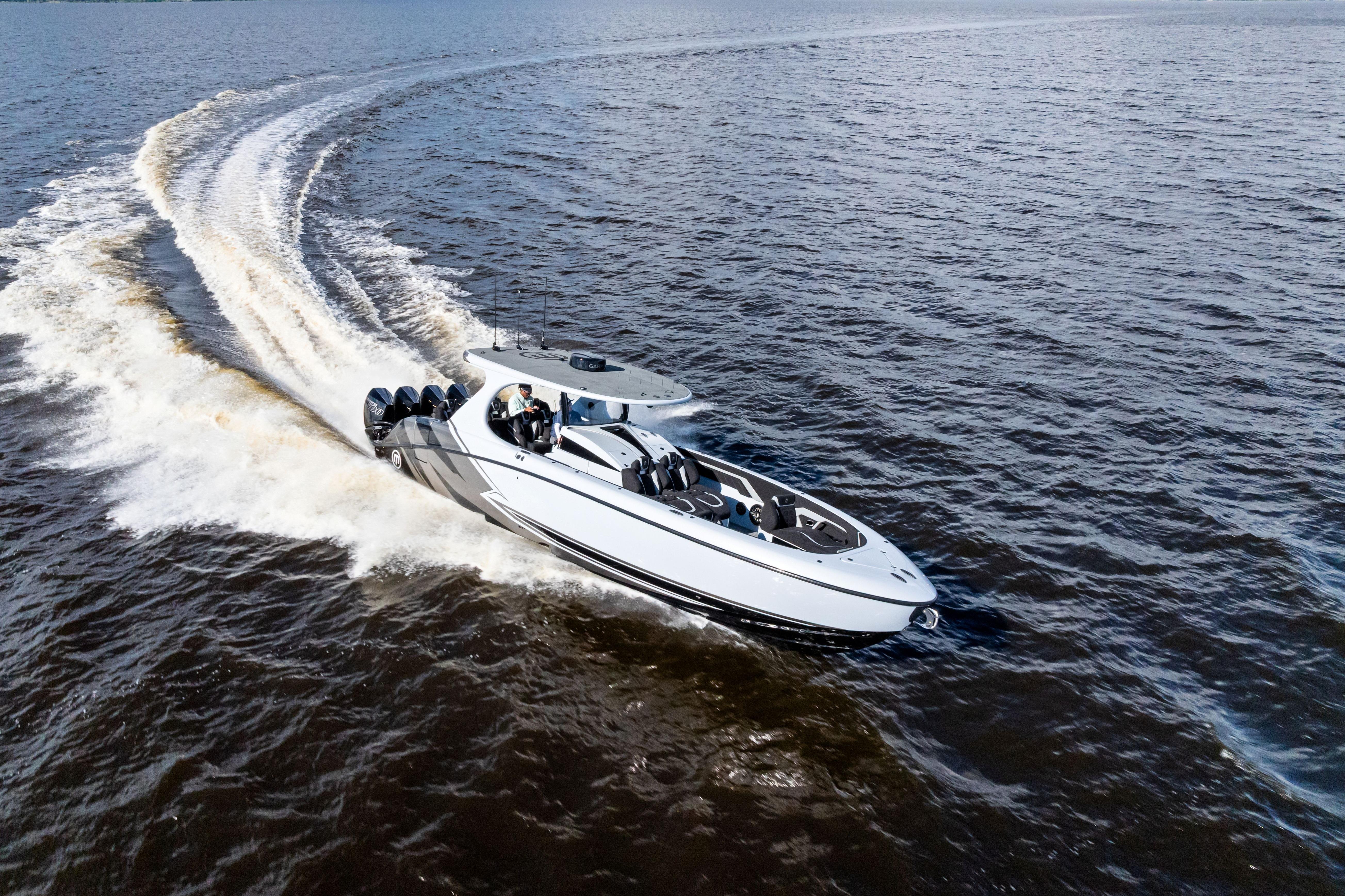 2027 Mystic Powerboats M4200 speeding on open water, showcasing sleek design and powerful engines.