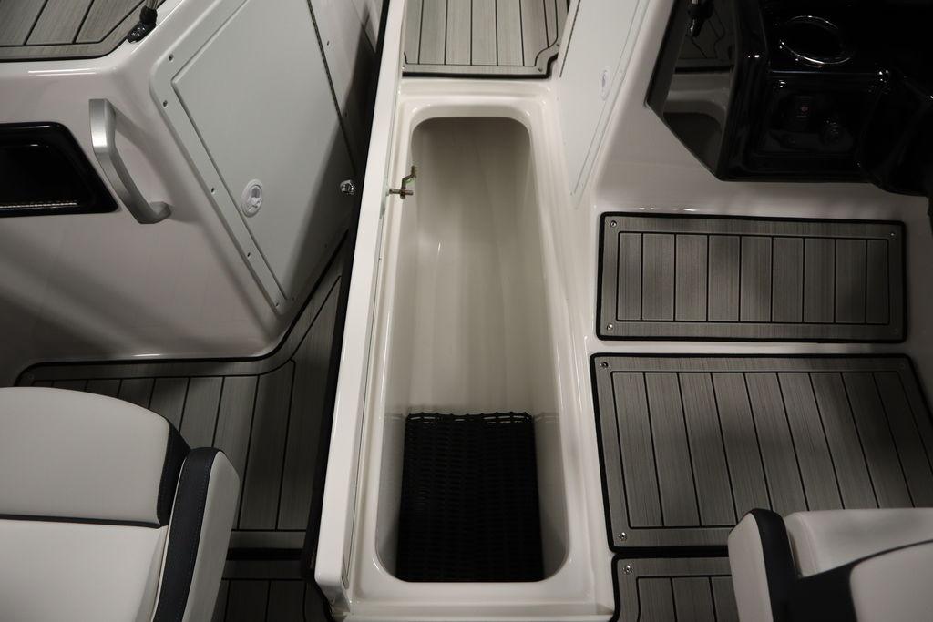 Interior view of 2026 Yamaha Boats 195S, showcasing storage compartment and seating area.