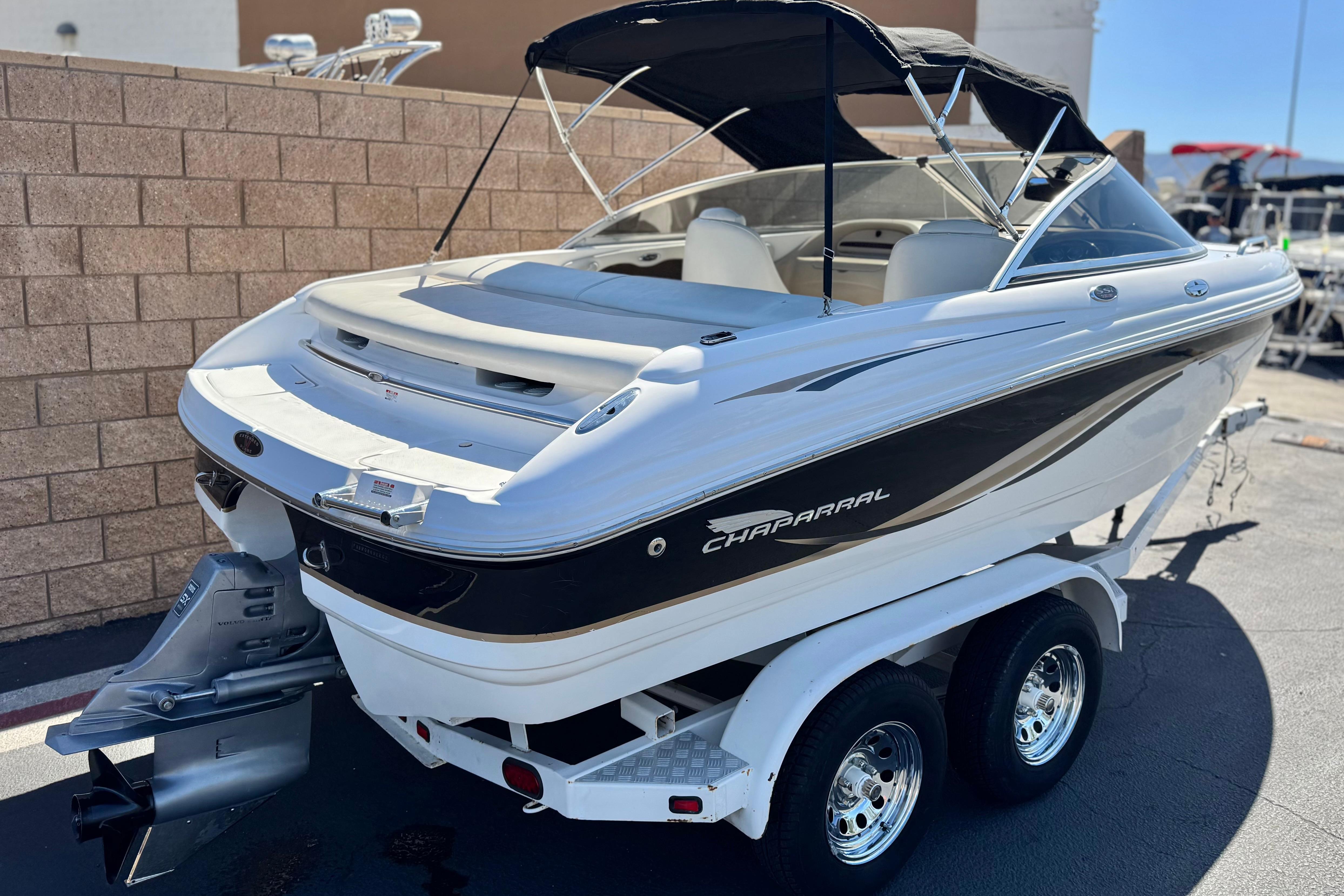 2002 Chaparral 186 SSi boat on trailer, featuring sleek design and black accents.