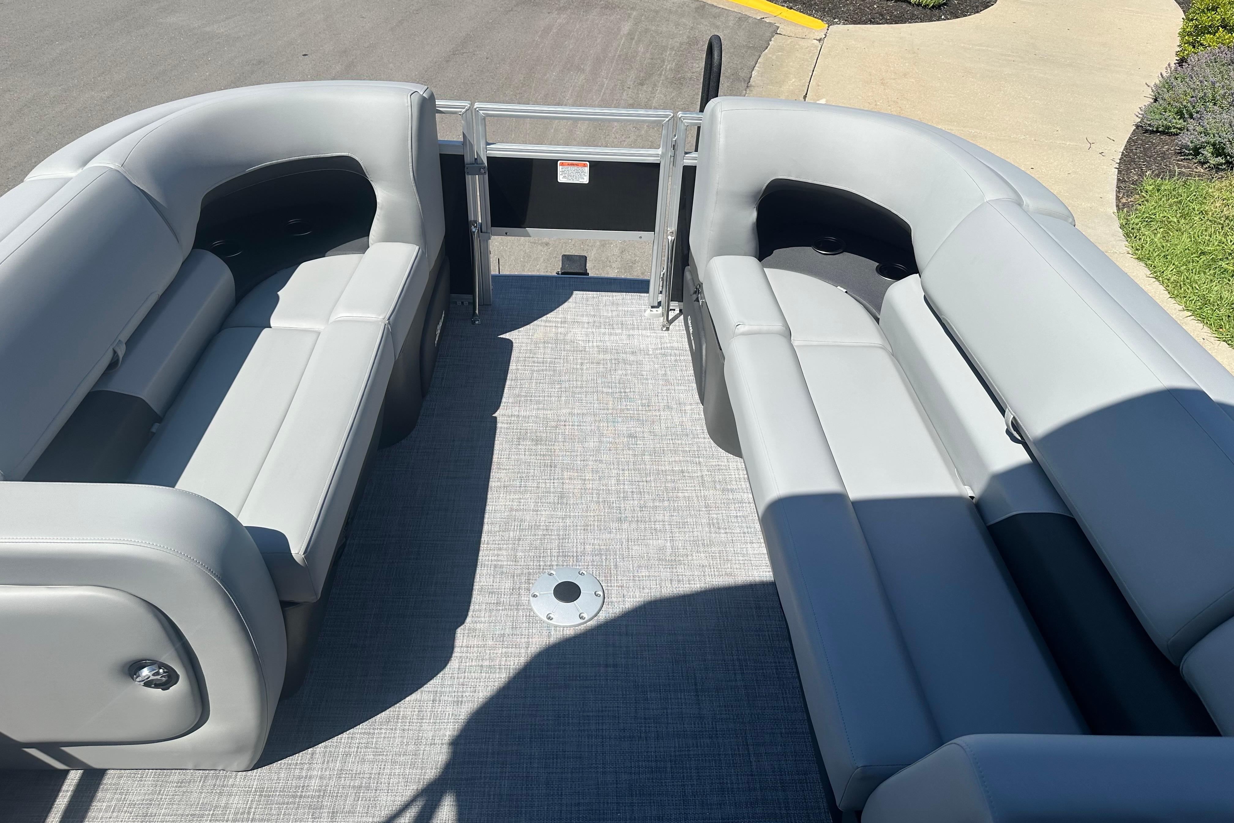 2026 Sun Tracker SportFish 22 DLX pontoon boat interior with gray seating and open deck.