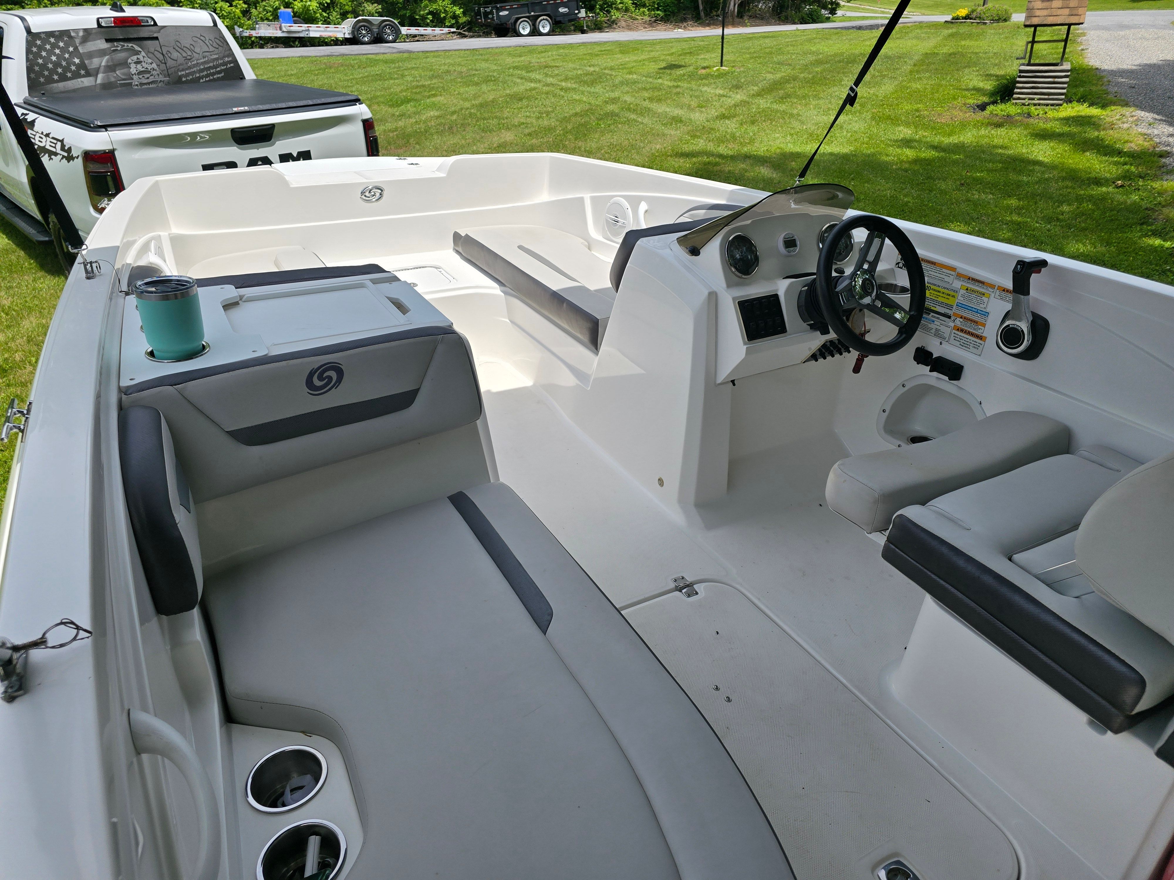 Interior of a 2021 Hurricane 205SS boat, featuring steering wheel and seating.