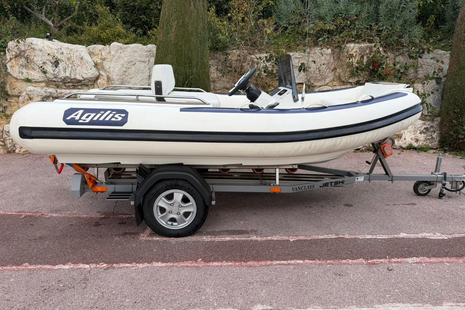 2022 Agilis 355C inflatable boat on trailer, parked outdoors.