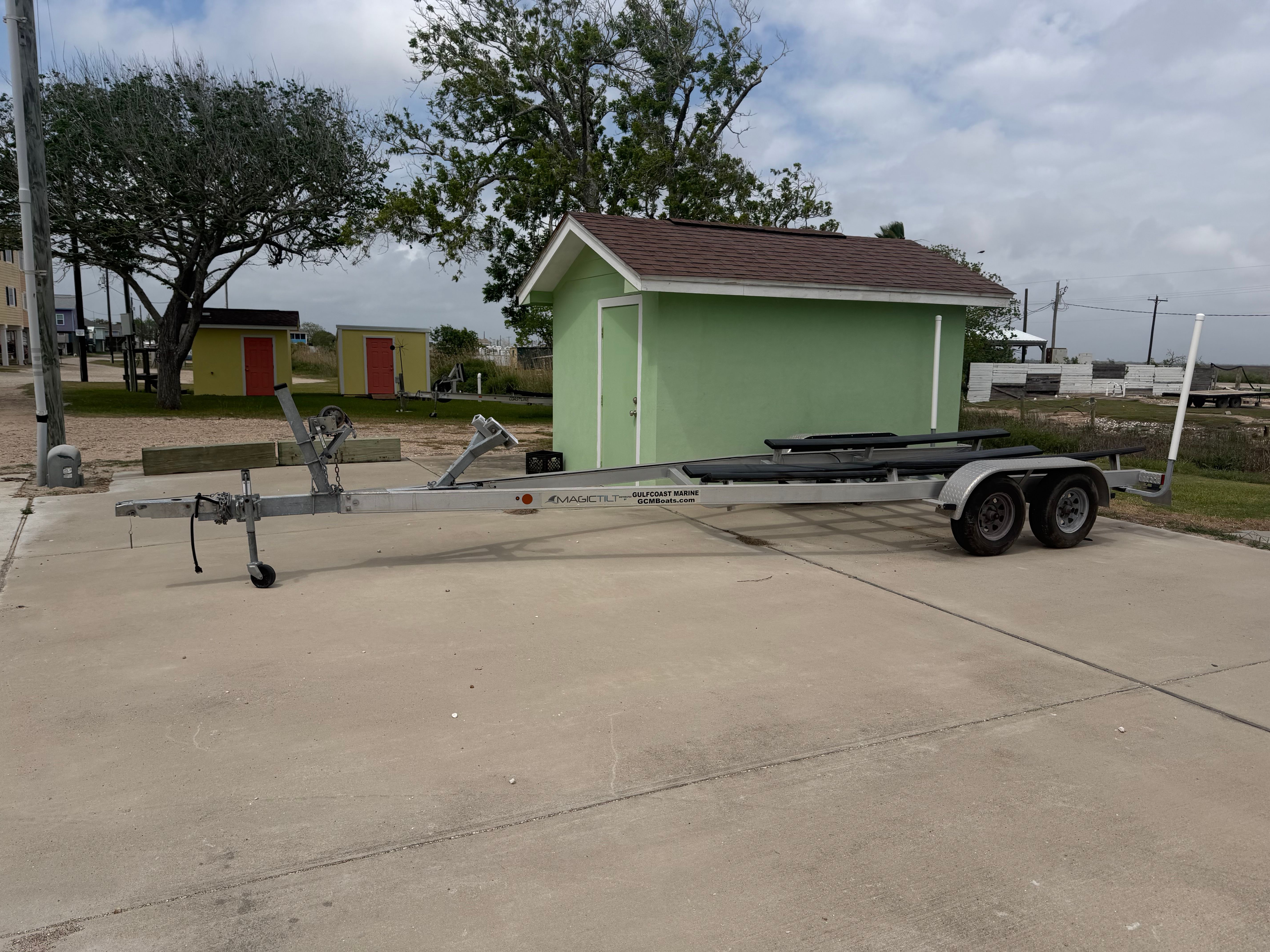 Boat trailer on concrete surface near green building, Sea Pro Citation 2021.