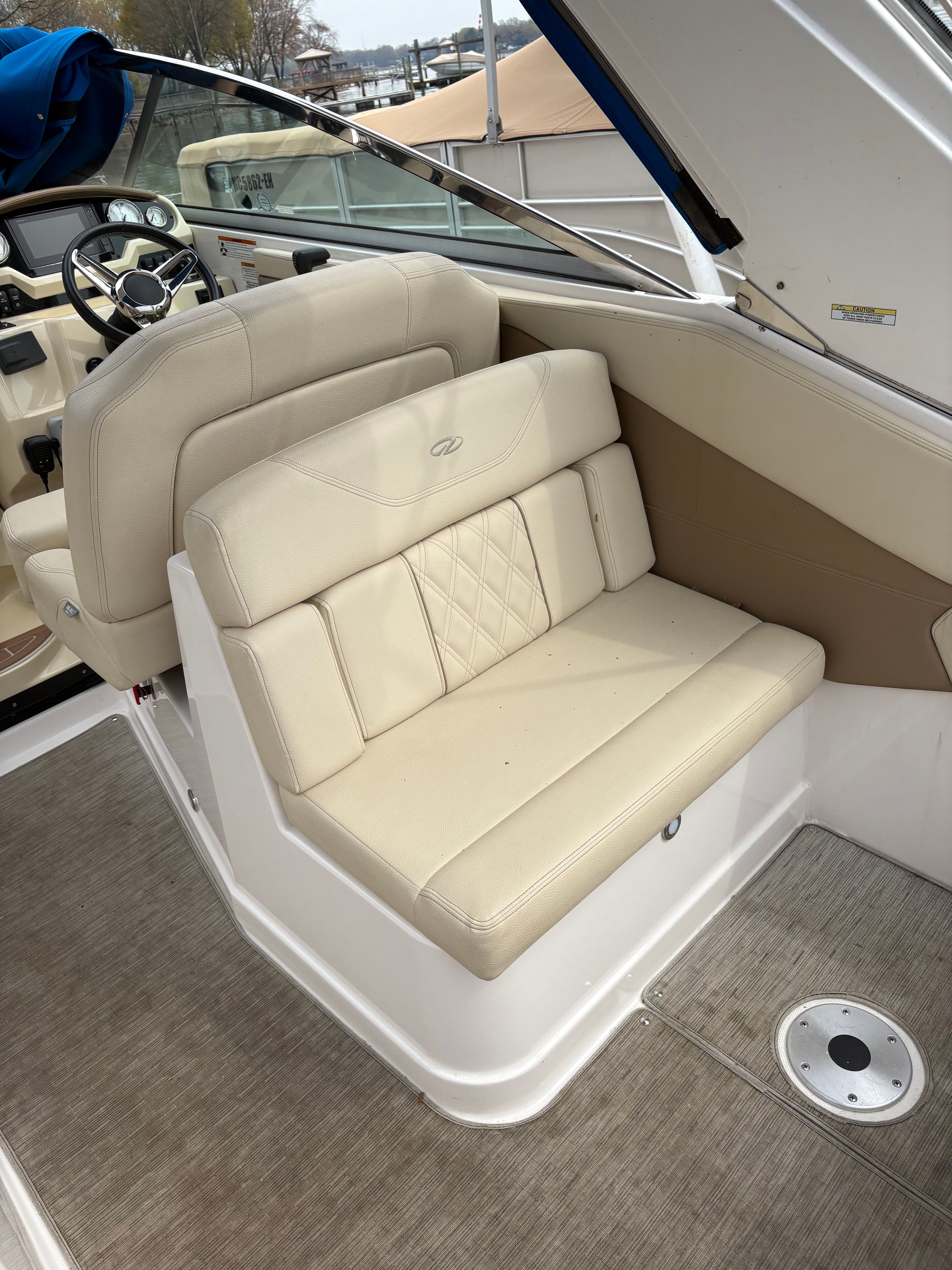 Interior of a 2019 Regal 28 Express boat with beige seating area.