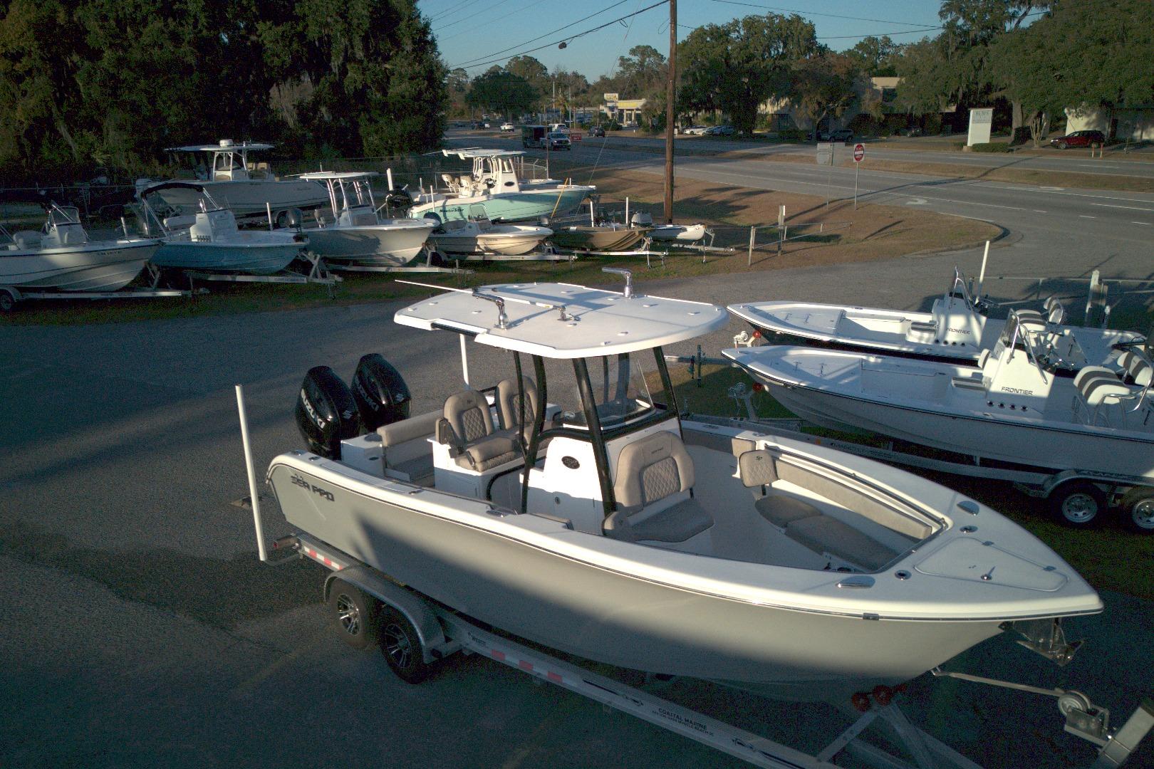 2021 Sea Pro 259 Center Console boat on trailer at dealership lot.