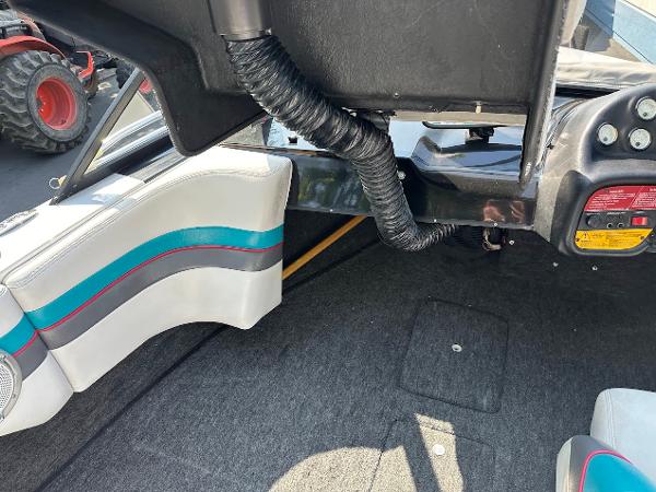 1992 Correct Craft Ski Nautique interior with gray carpet and white seats featuring blue and red accents.