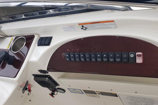 Control panel of a 2010 Meridian 441 Sedan yacht with labeled switches and warning labels.