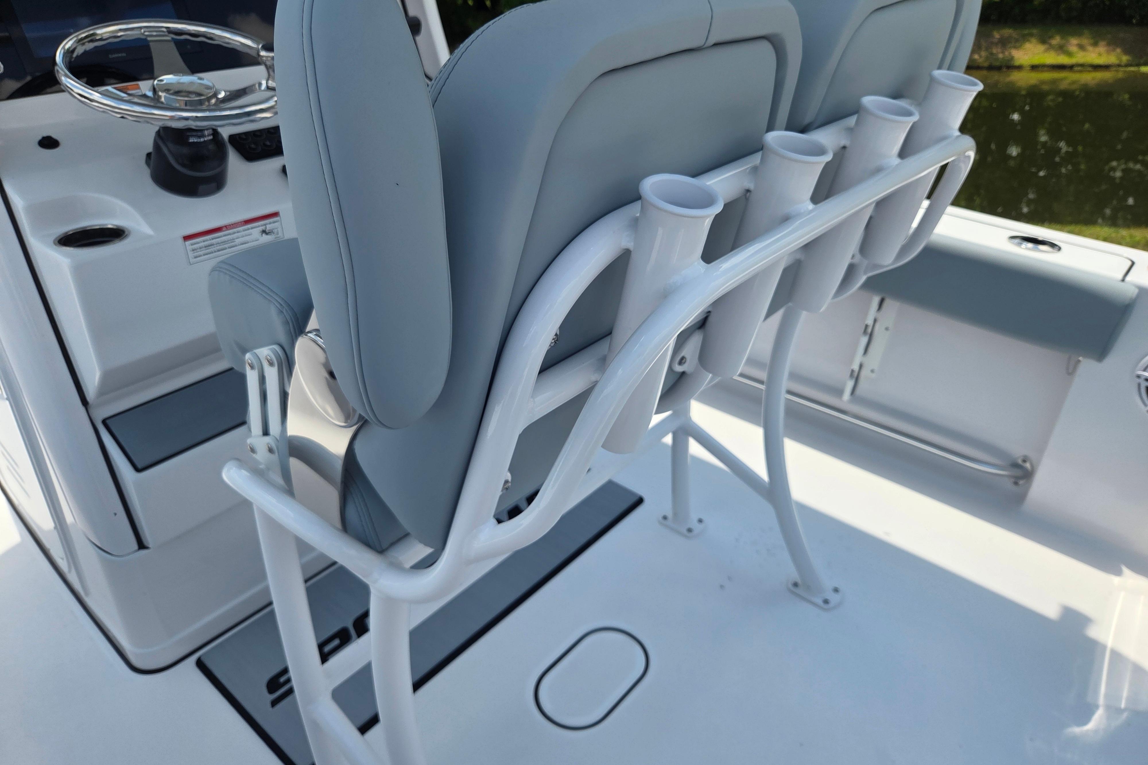 2026 Sportsman Open 212 Center Console boat interior with rod holders and seating.