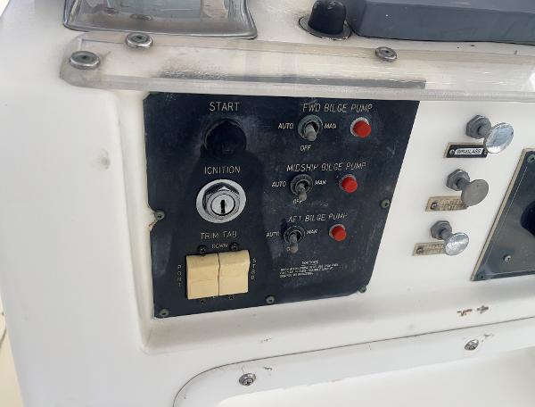 Control panel of a 1985 Hatteras 45 Convertible boat with ignition and bilge pump switches.