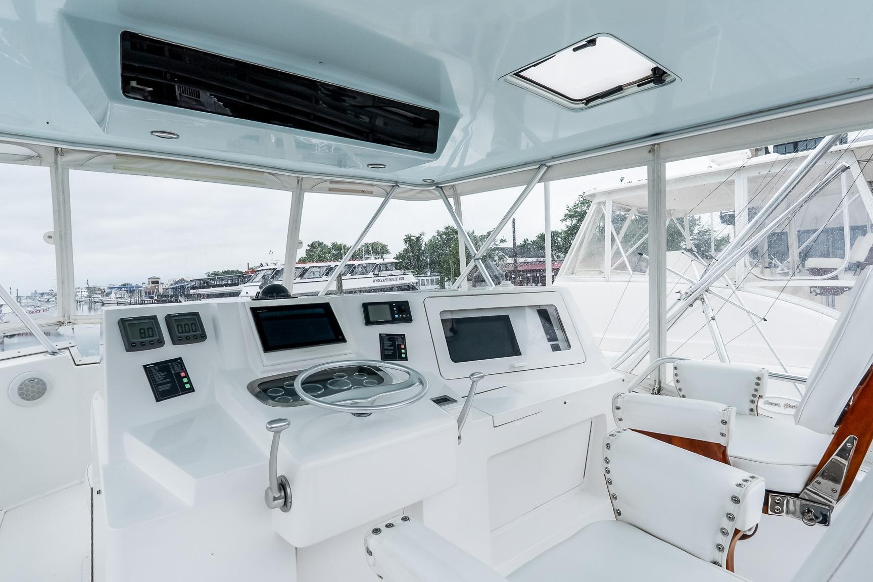 Helm of 2000 Viking 50' Convertible yacht with modern controls and seating.
