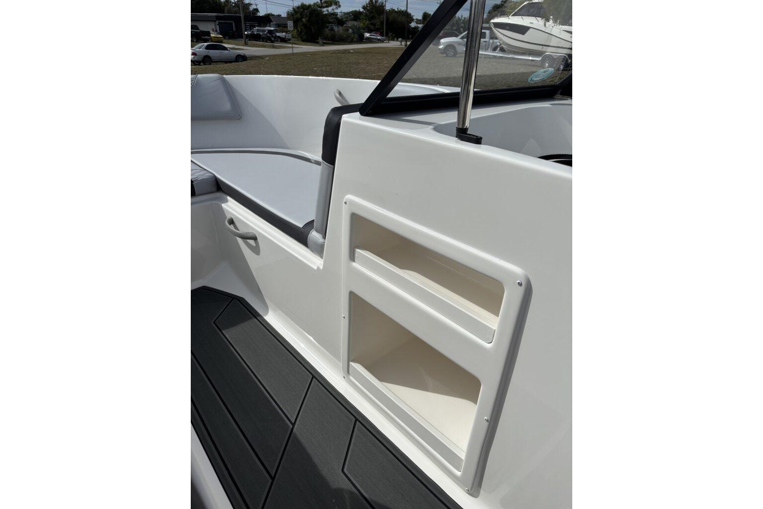 2025 Bayliner Element M17 interior with storage compartments and seating area.