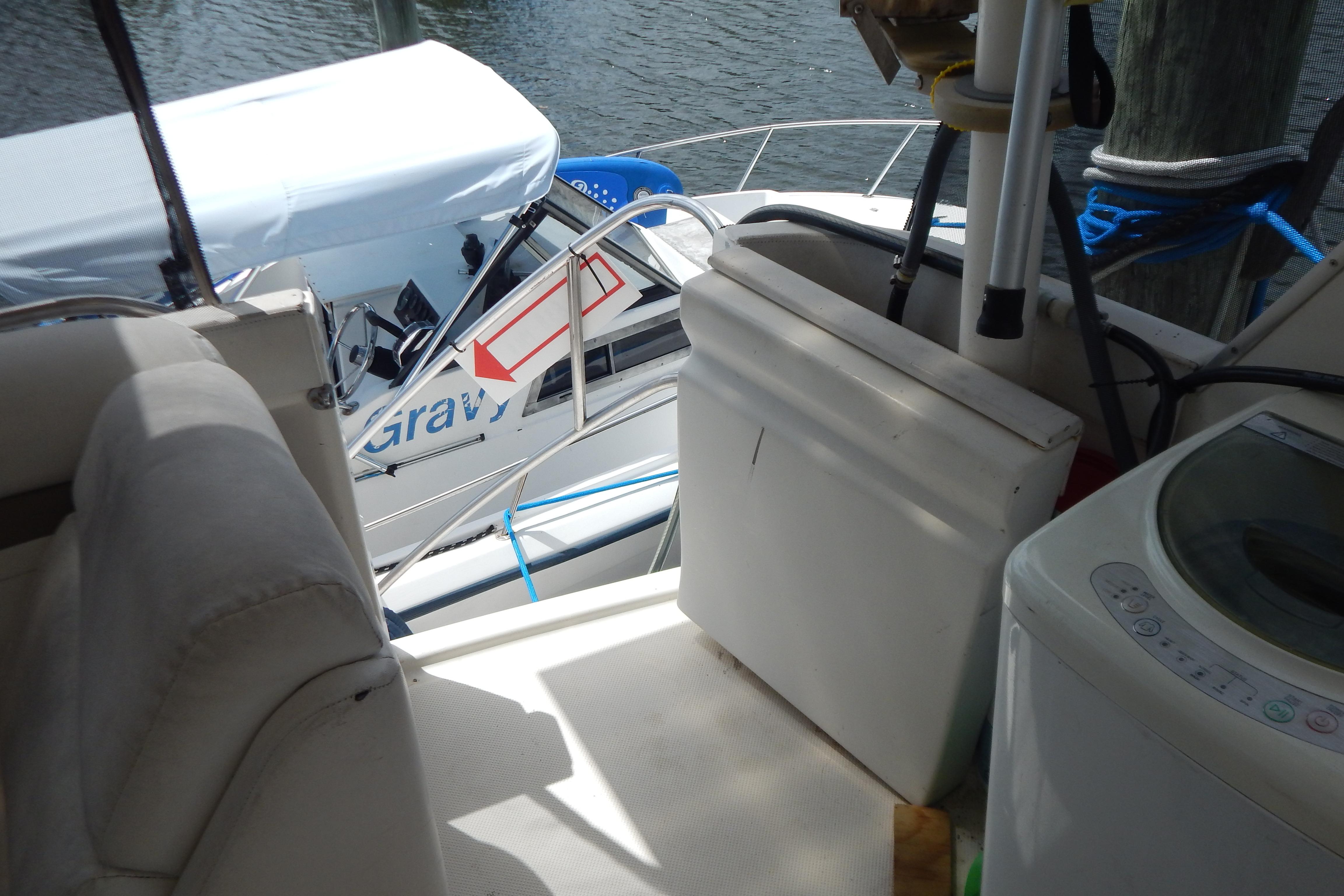 Interior view of a 1998 Magnum 4100 SCR boat docked beside another vessel.