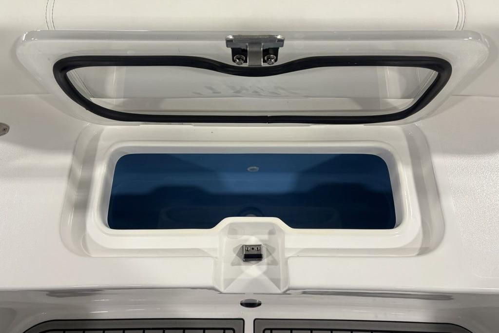 Livewell compartment on 2026 Tidewater 3100 Carolina Bay boat, open lid view.
