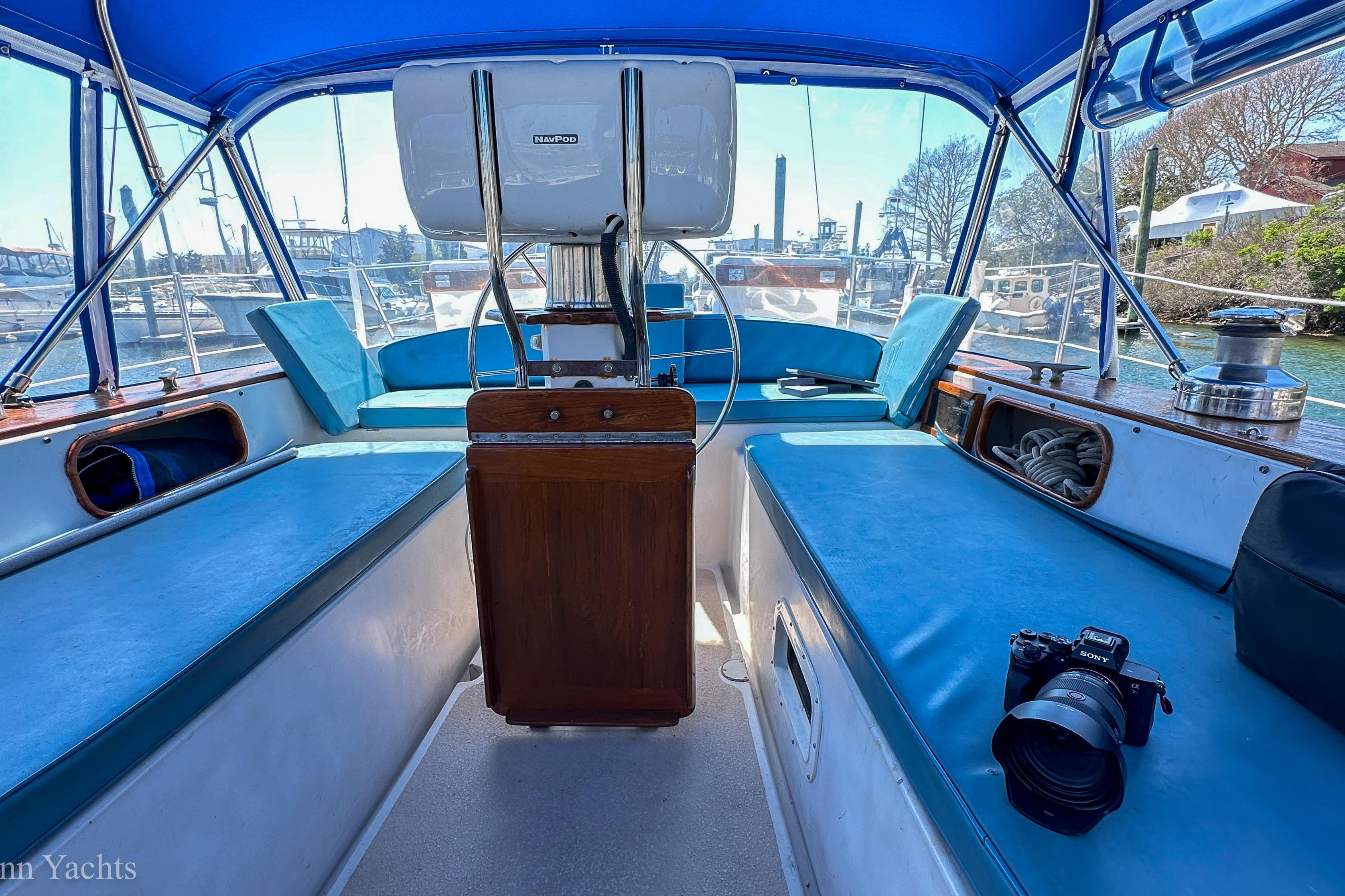 Interior view of 1980 Irwin 46 yacht cockpit with blue seating and steering wheel.
