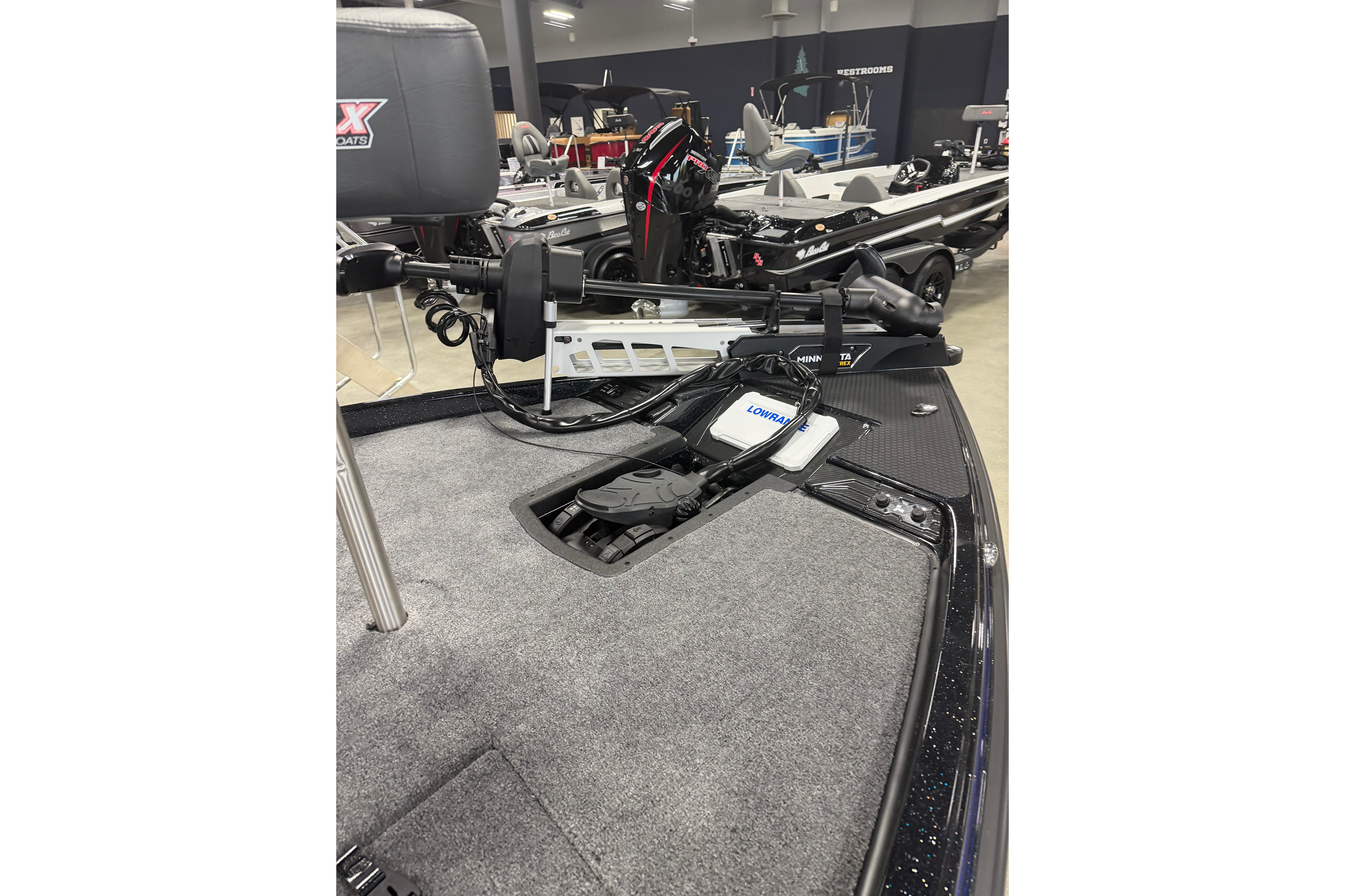 2027 Phoenix 721 ZXL boat interior with advanced fishing equipment and carpeted deck.