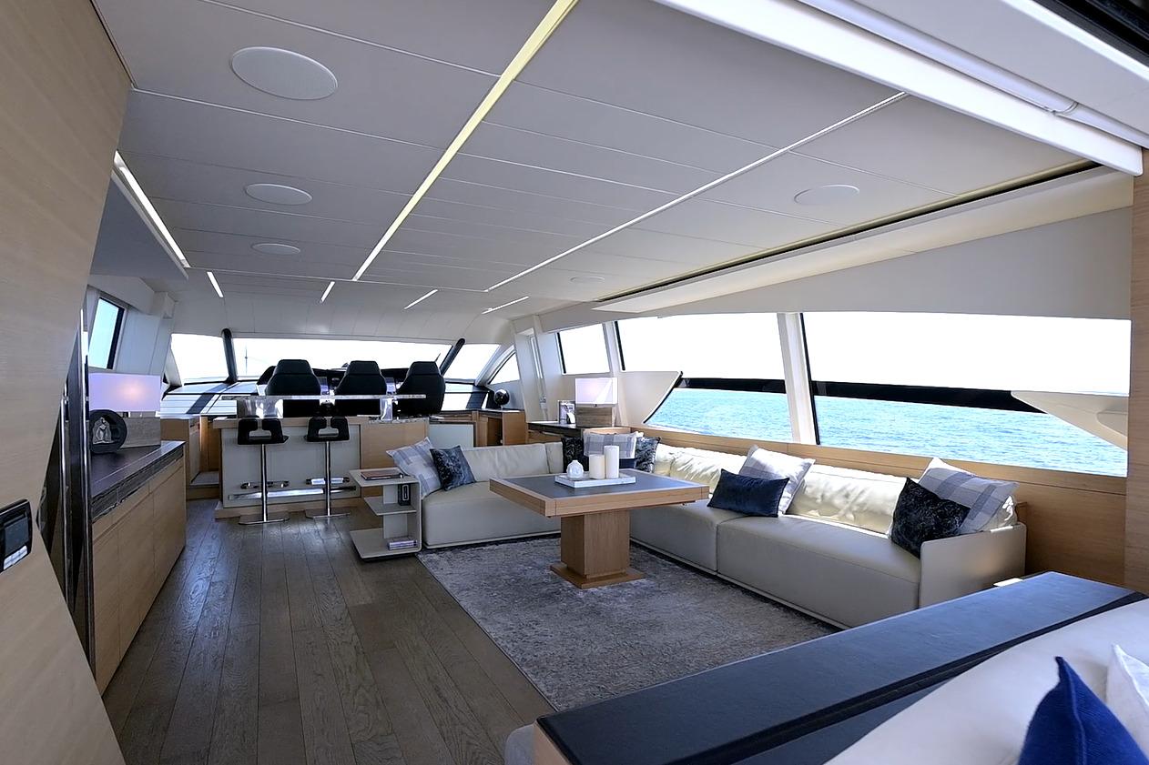 Luxurious interior of a 2015 Pershing 92 yacht with modern seating and ocean view.