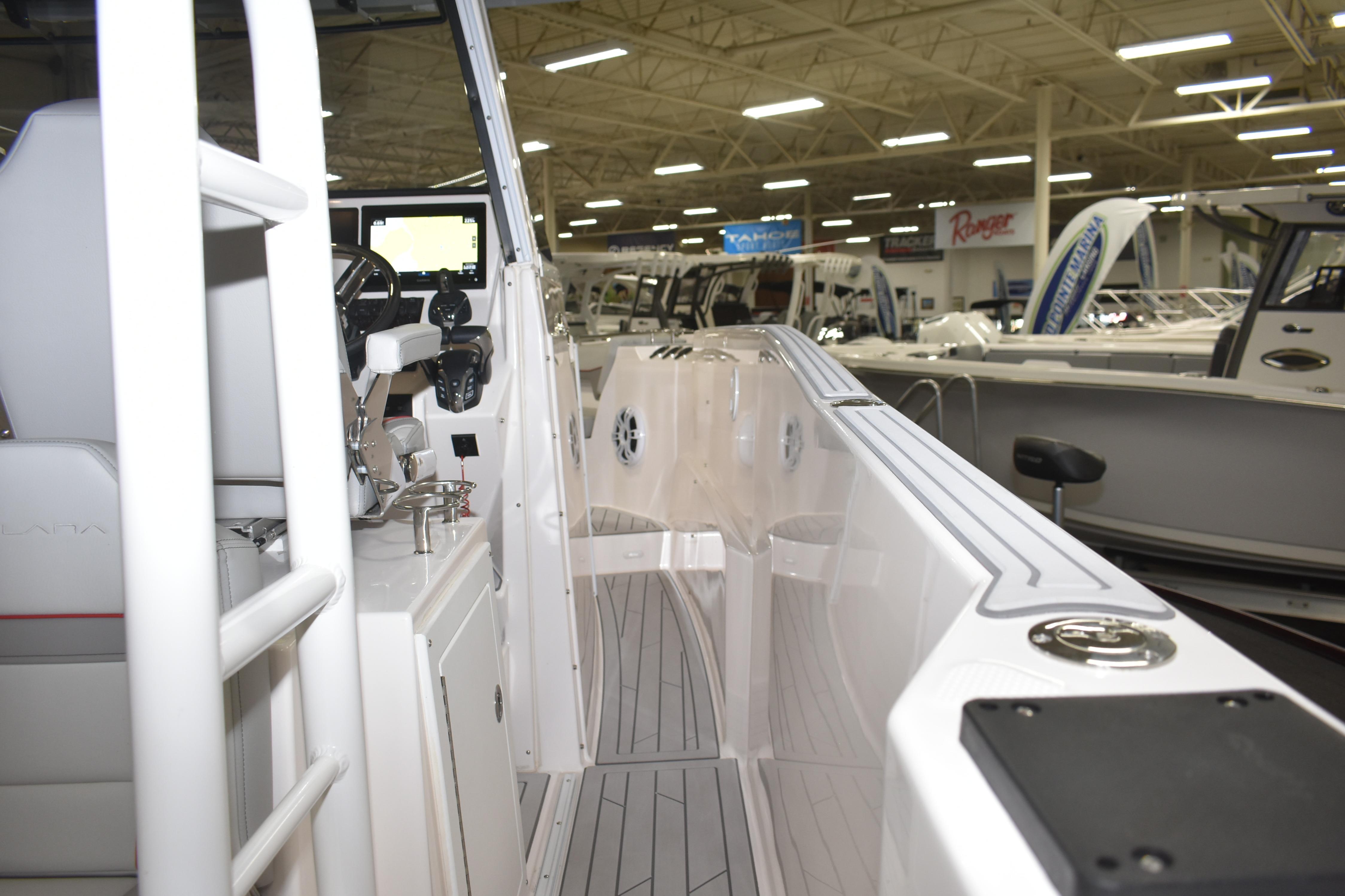2025 Solara S-310 CW boat interior at a showroom, featuring modern controls and seating.