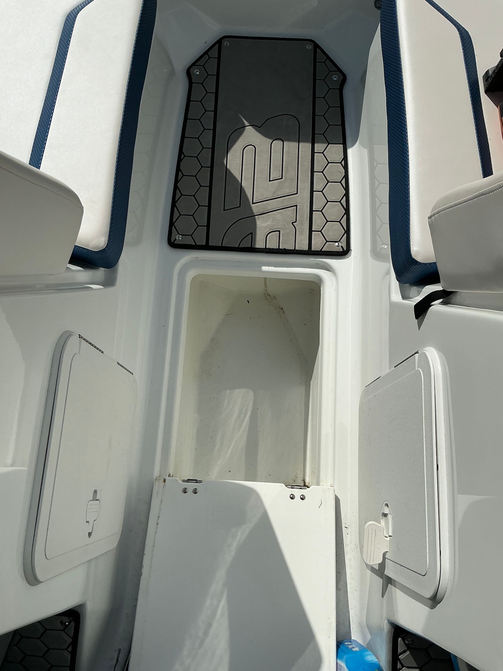 Interior of a 2021 Scarab 215 ID boat with storage compartments.