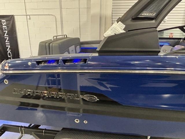 2026 Chaparral SSX 6 boat, blue exterior, sleek design, displayed indoors.