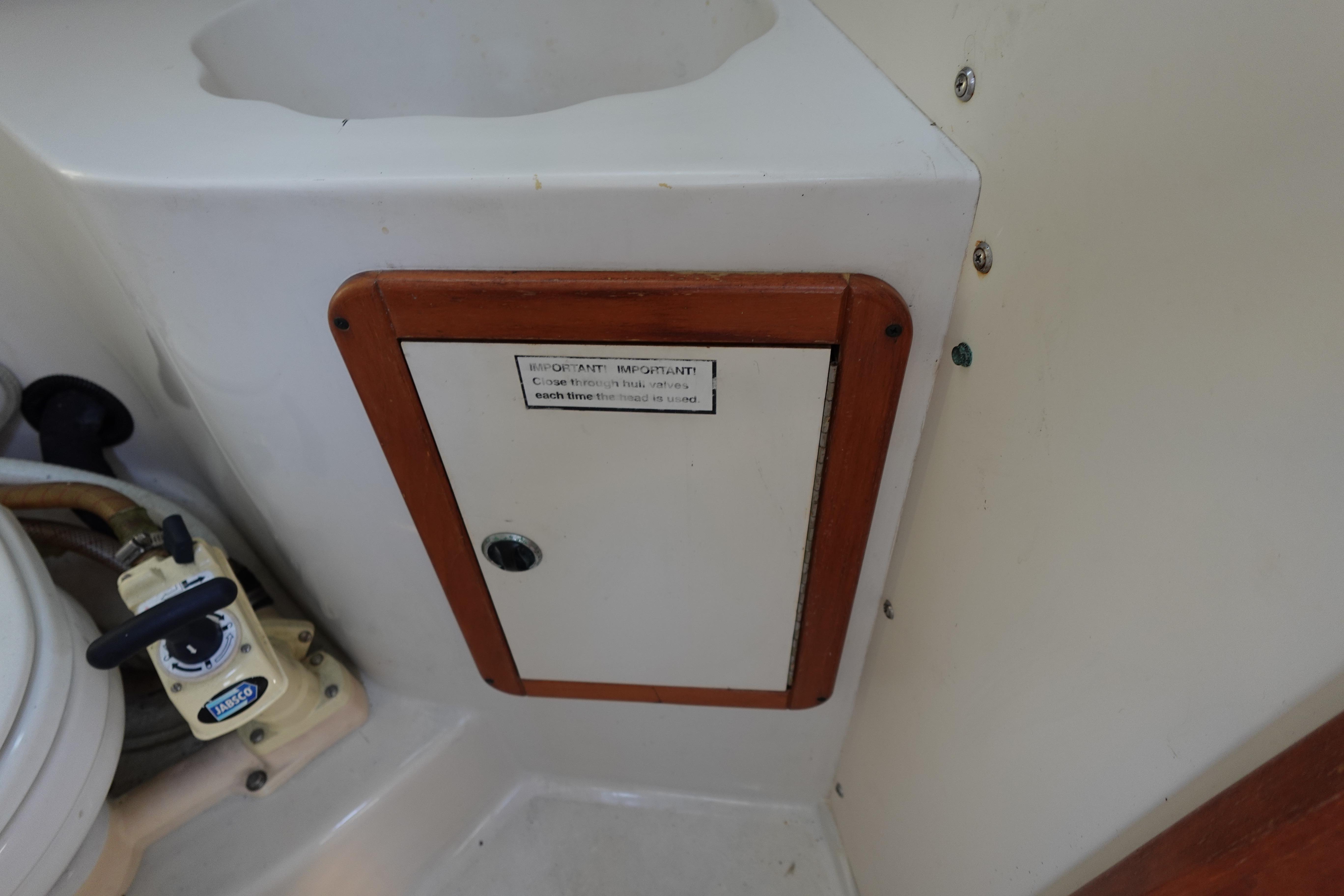 Interior of a 1997 Catalina 28 sailboat showing a small storage compartment.