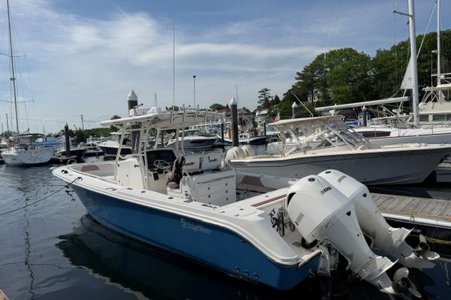 2014 Edgewater 318CC boat docked at a marina with twin outboard engines.