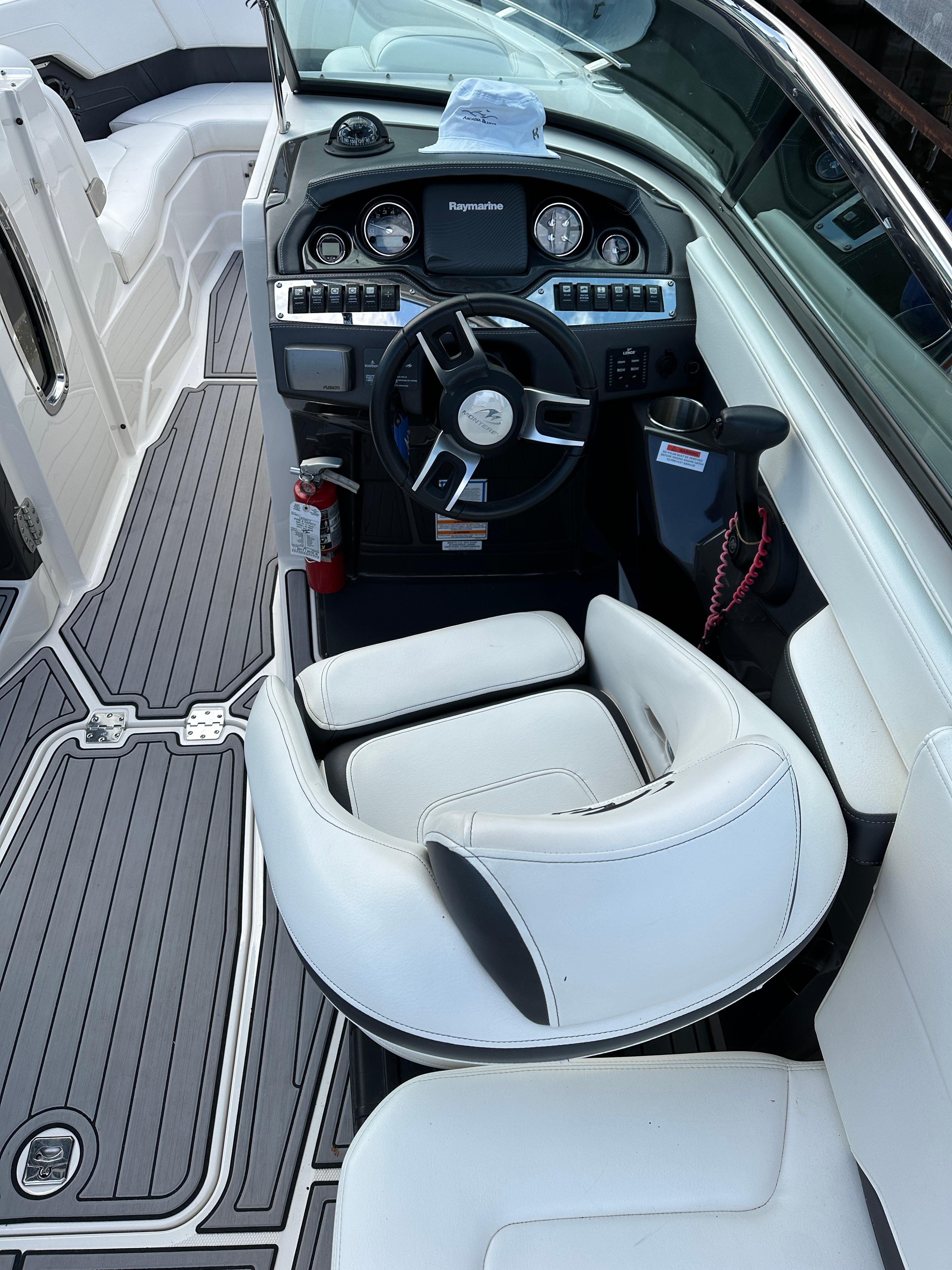 2014 Monterey 268 Super Sport boat interior with steering wheel and seating.