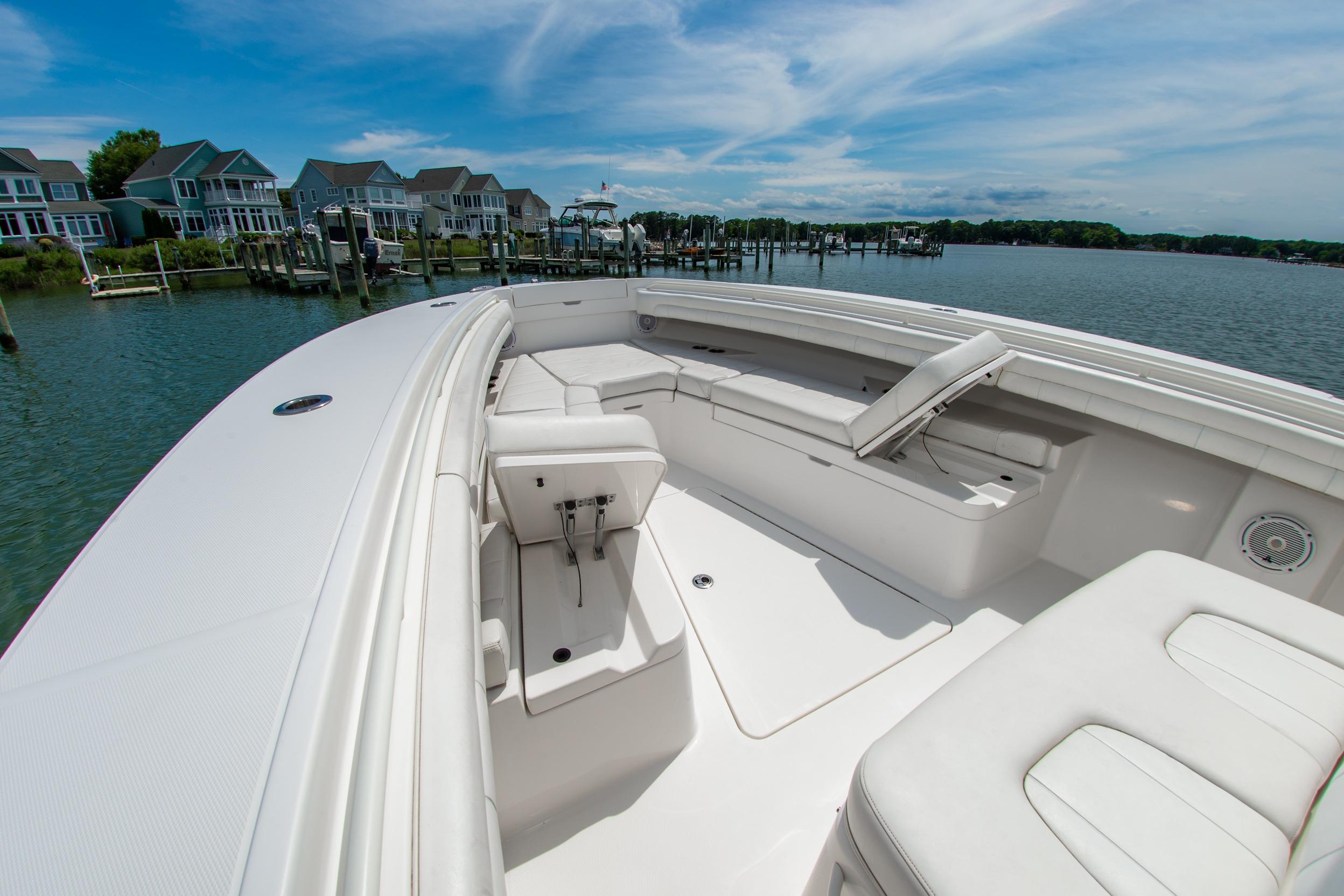 2019 Regulator 31 boat with spacious seating, docked near waterfront homes.