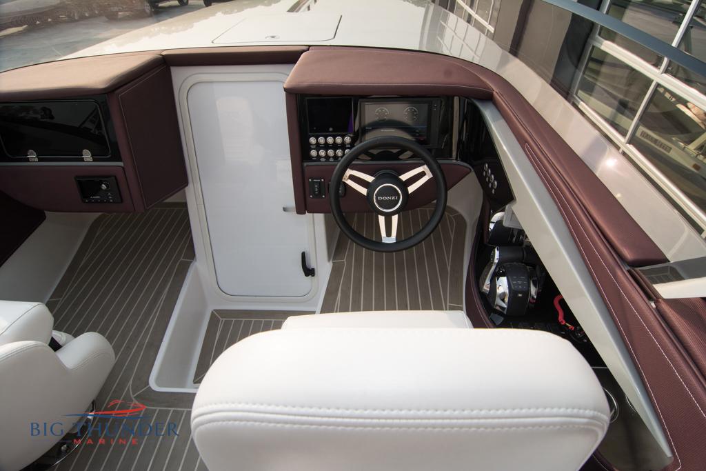 2019 Donzi 41 GT boat cockpit with steering wheel and control panel.