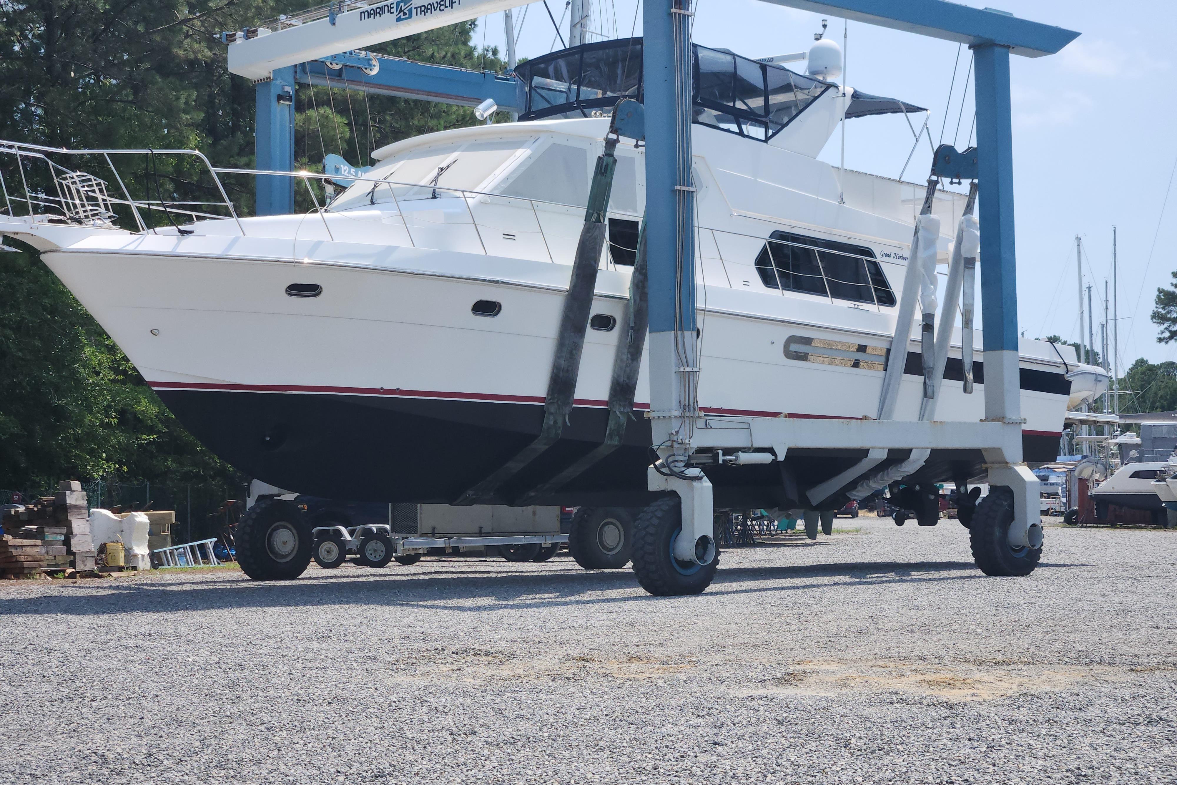 Grand Harbour 58 yacht from 2004 in a boatyard lift, ready for maintenance.