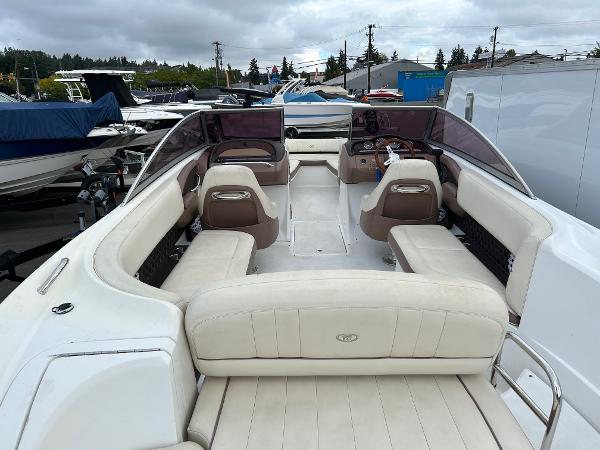 2010 Cobalt 262 boat with spacious seating and sleek design, docked outdoors.