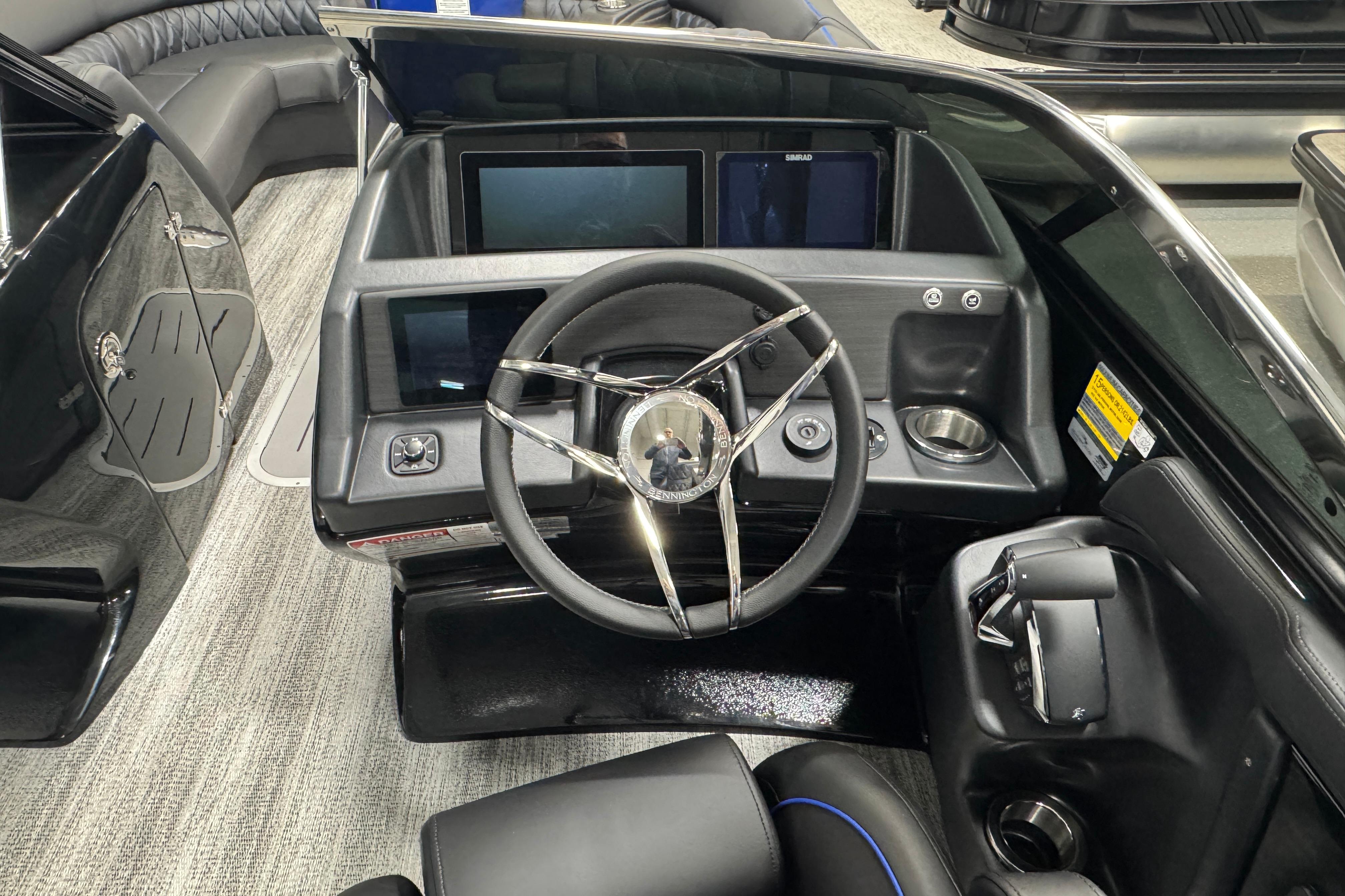 2026 Bennington 25 QSBWASE boat dashboard with modern steering and digital displays.