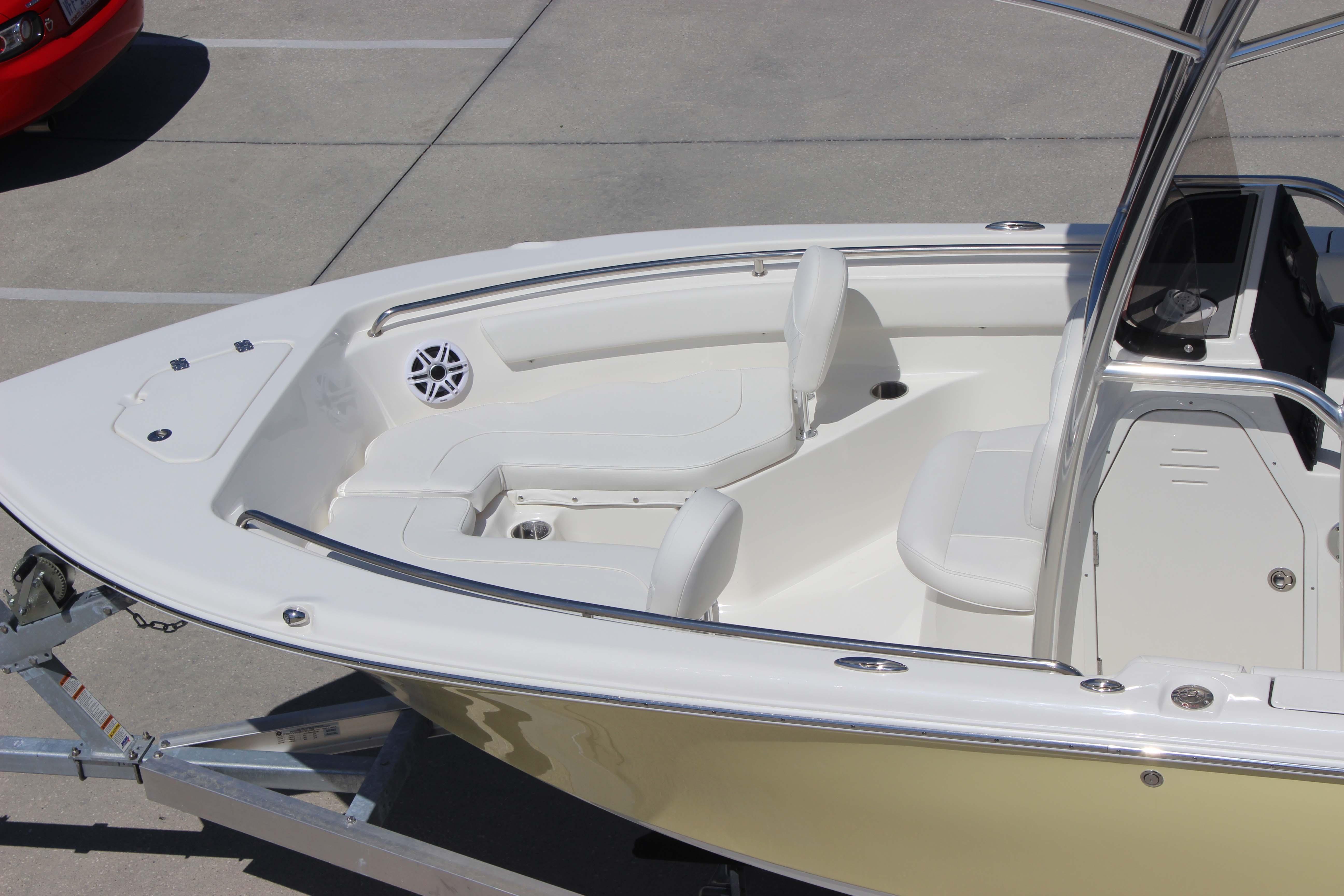 2026 Key West 203 FS boat interior with seating and console, parked on a trailer.