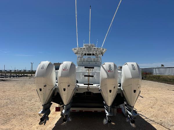 2022 Freeman 42LR boat with four powerful outboard engines, viewed from the rear.