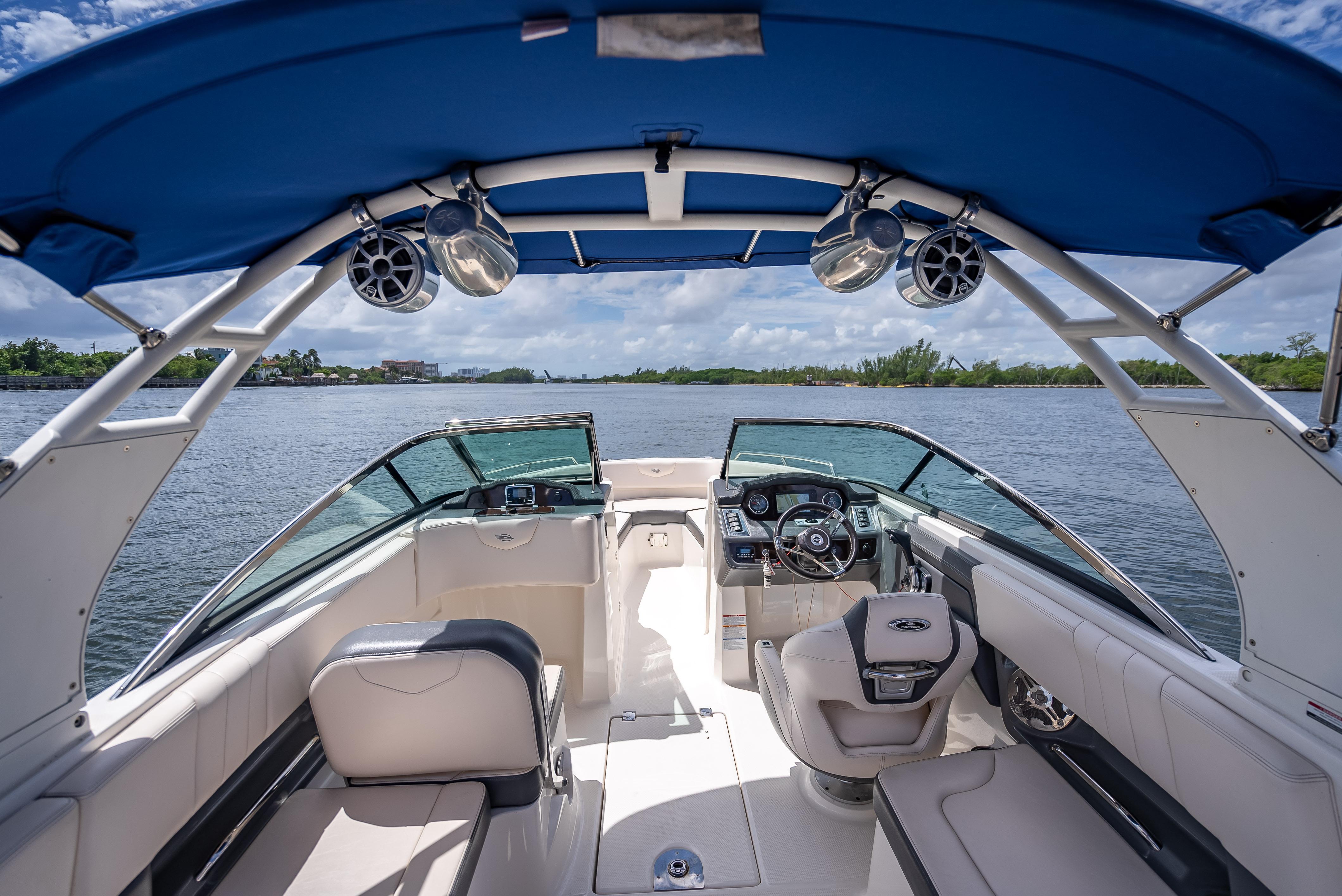 2017 Chaparral 227 SSX boat interior with blue canopy and scenic water view.
