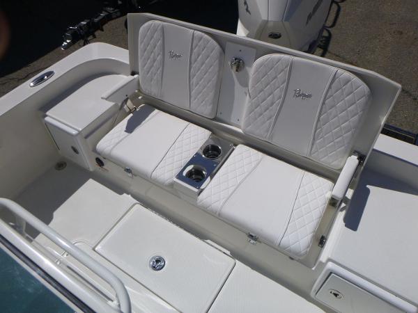 2024 Ranger 2360 Bay boat with white cushioned seating and cup holders.