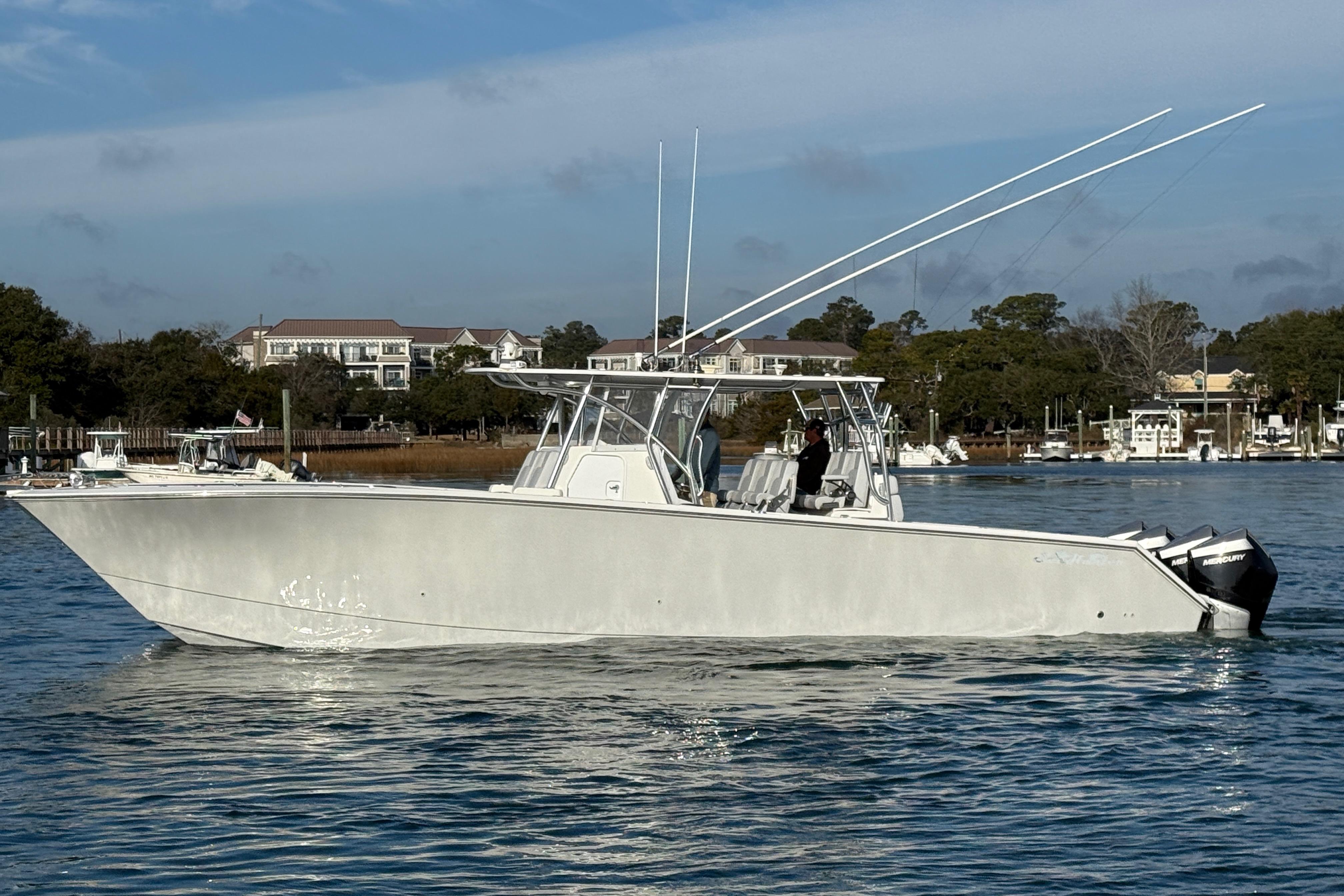 2021 SeaHunter 41 CTS boat on calm water with scenic background.