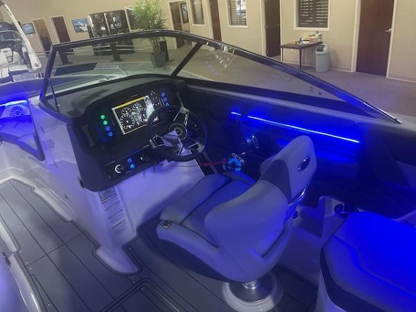 2025 Chaparral 267 SSX boat interior with illuminated dashboard and seating.