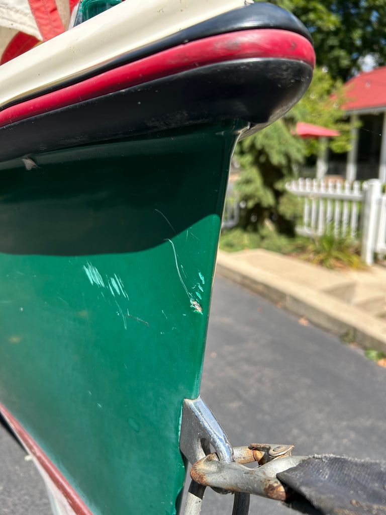 Close-up of a green 1995 Elco Launchboat with scratches.