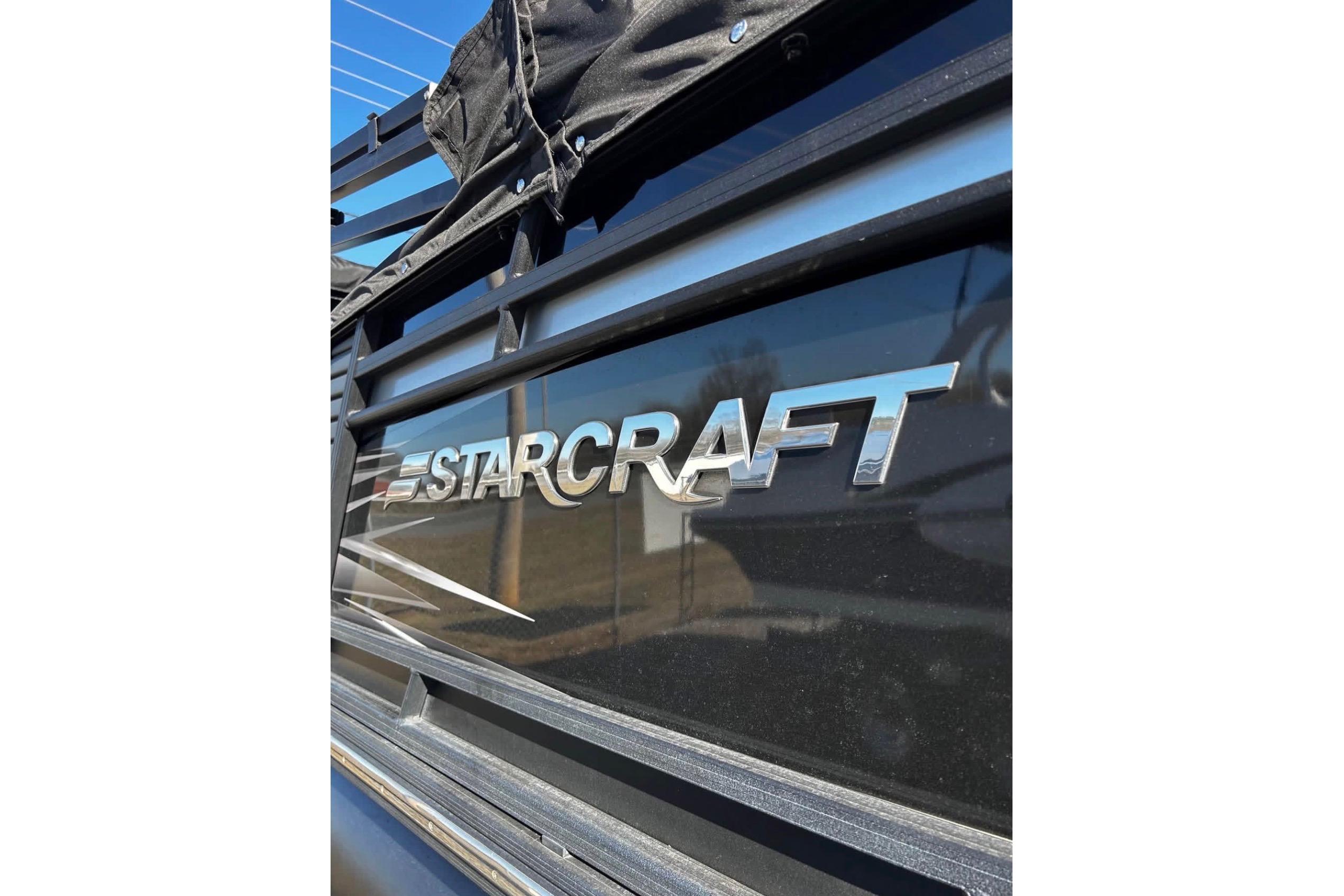 2023 Starcraft MX 25 DL DH boat logo on a sleek black surface.
