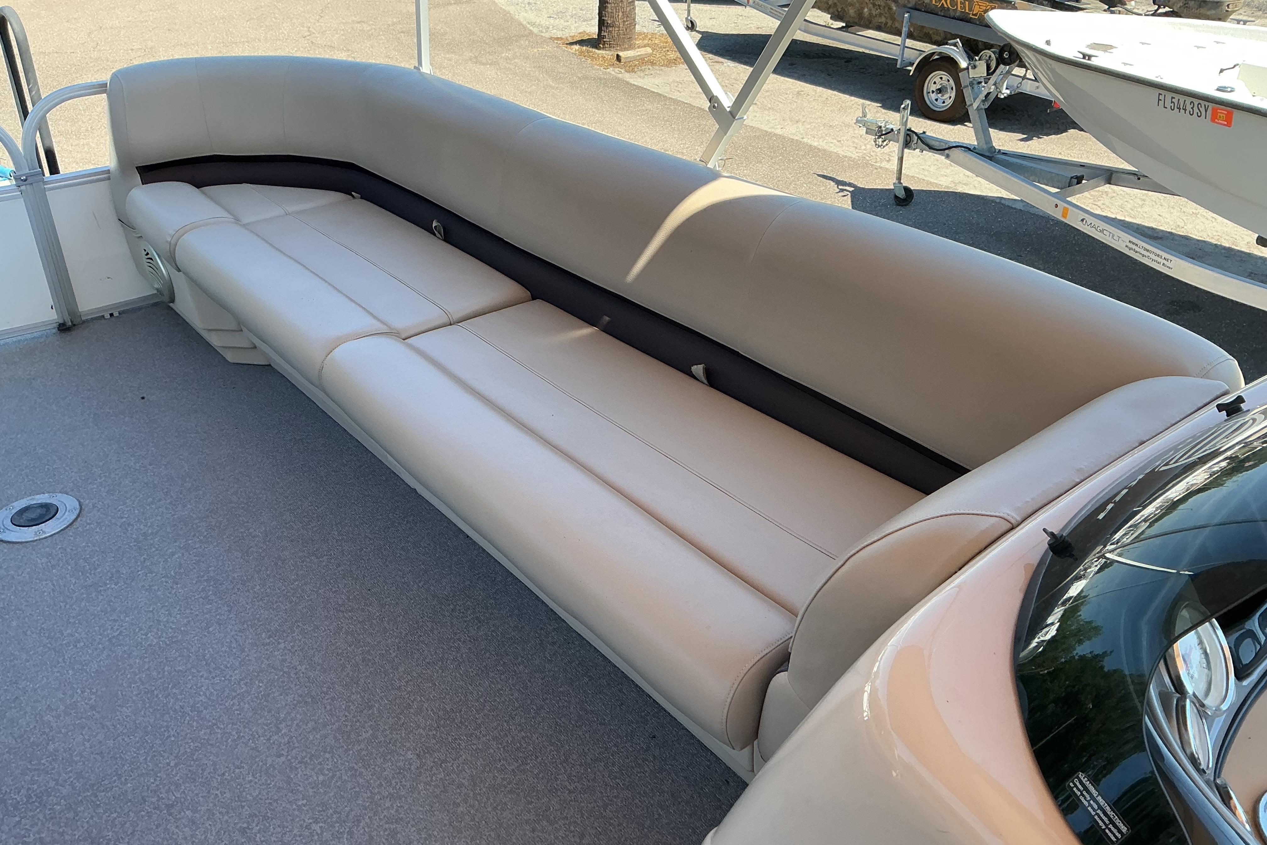 2017 Sun Tracker Party Barge 24 DLX with spacious beige seating on deck.