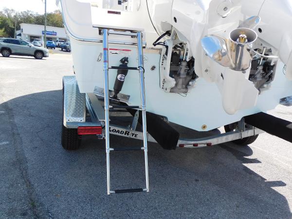 2024 Sailfish 242 CC boat on Load Rite trailer with ladder and dual outboard motors.