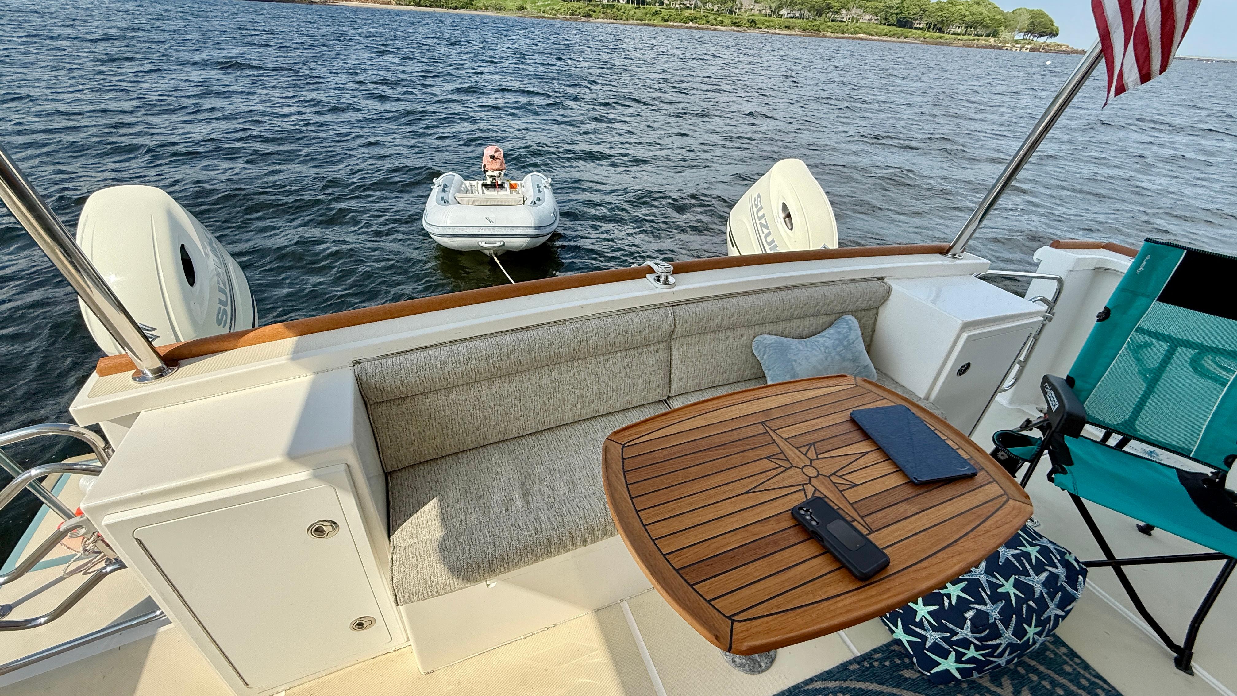 2014 Maine Cat P44 boat interior with table, seating, and view of water.
