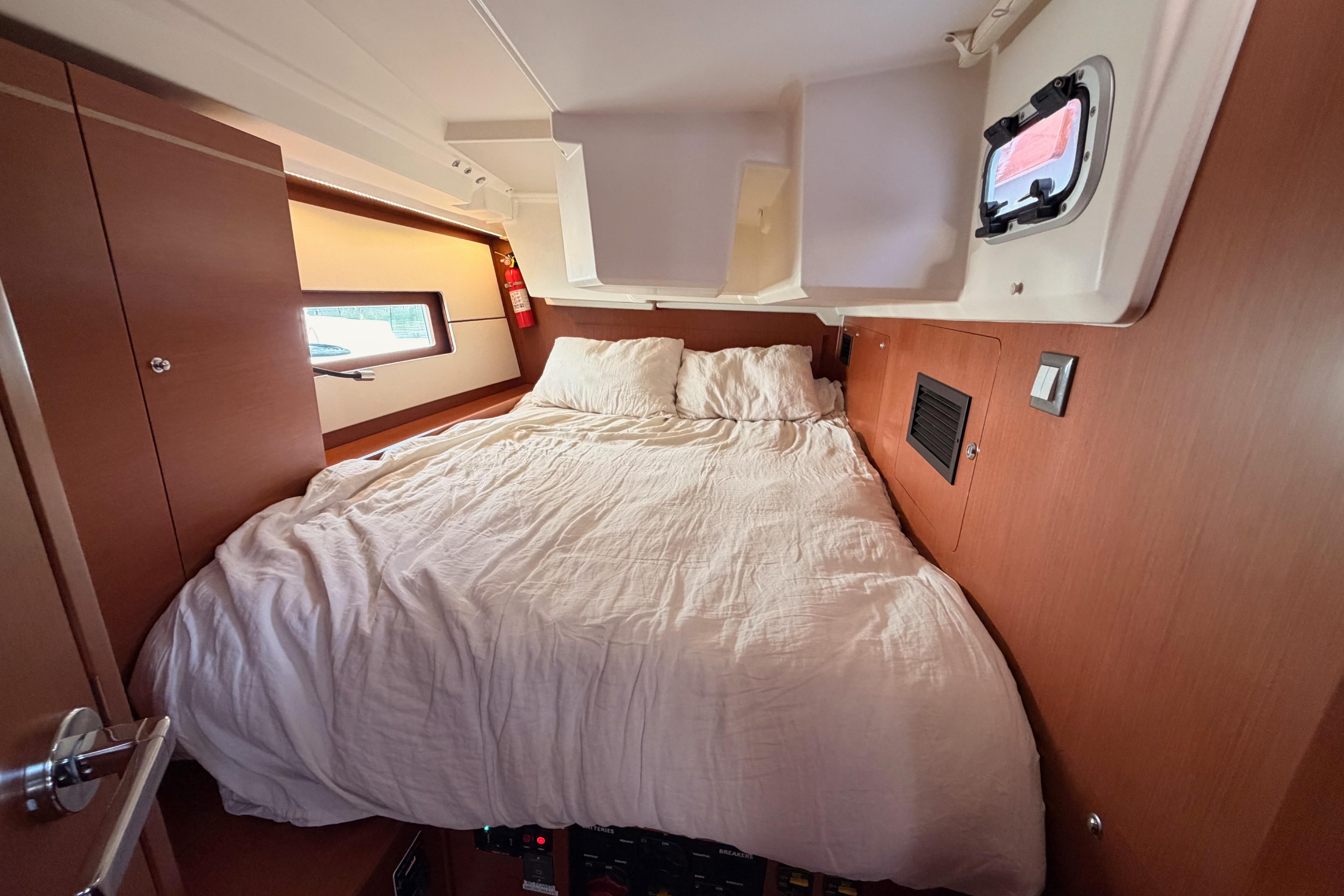 Cozy cabin interior of 2020 Beneteau Oceanis 46.1 yacht with comfortable bed.