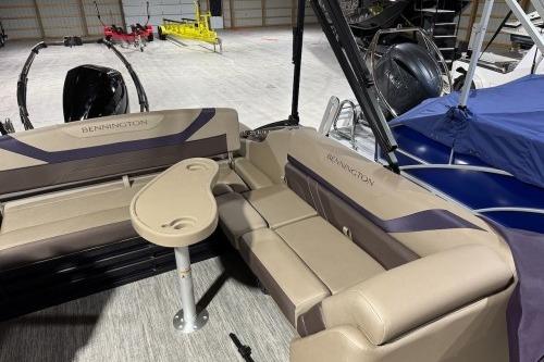 2026 Bennington 22SXSB pontoon boat interior with beige seating and a small table.