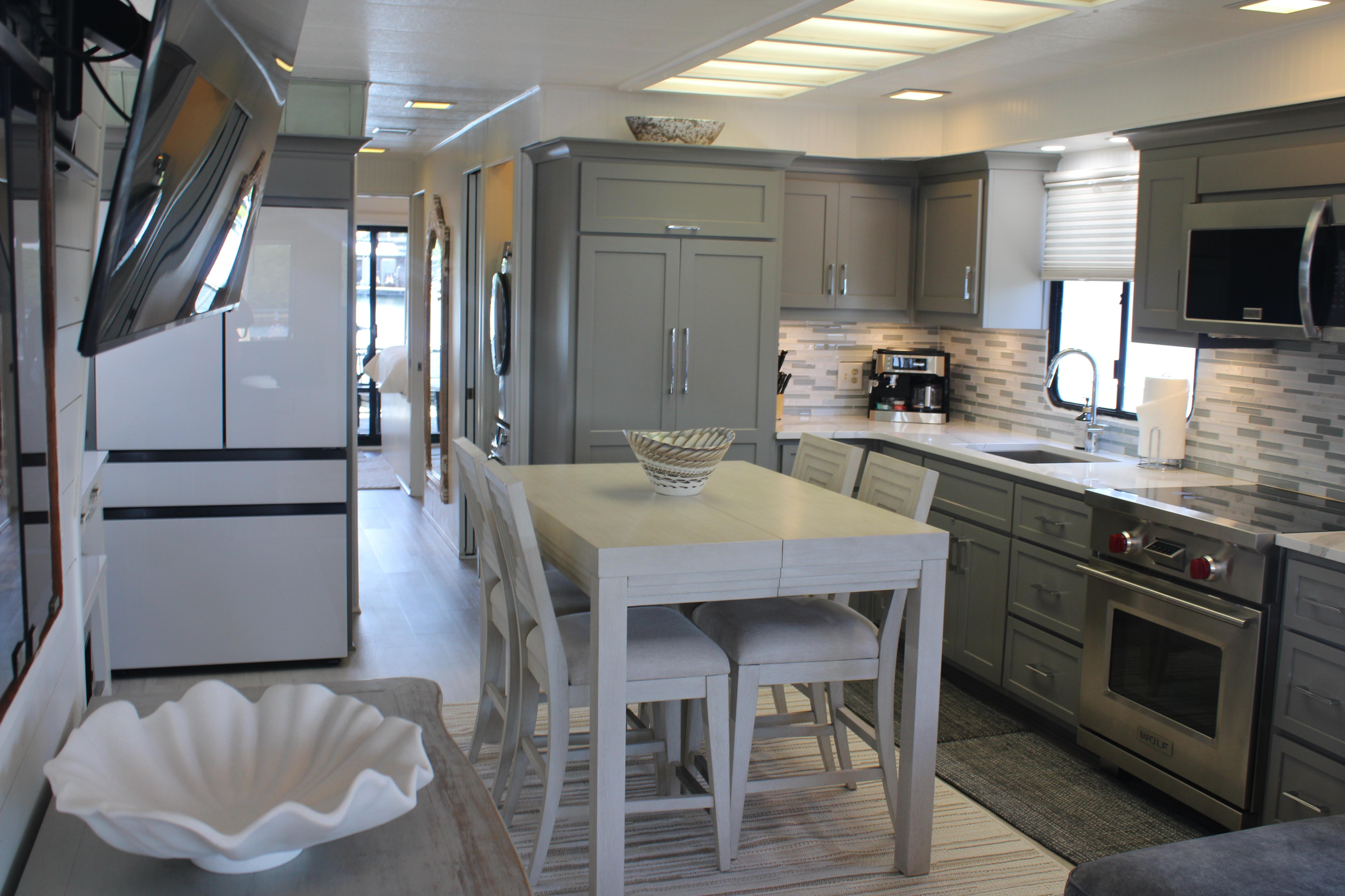 Modern kitchen interior in a 1992 Sumerset 66 houseboat, featuring sleek appliances and stylish cabinetry.