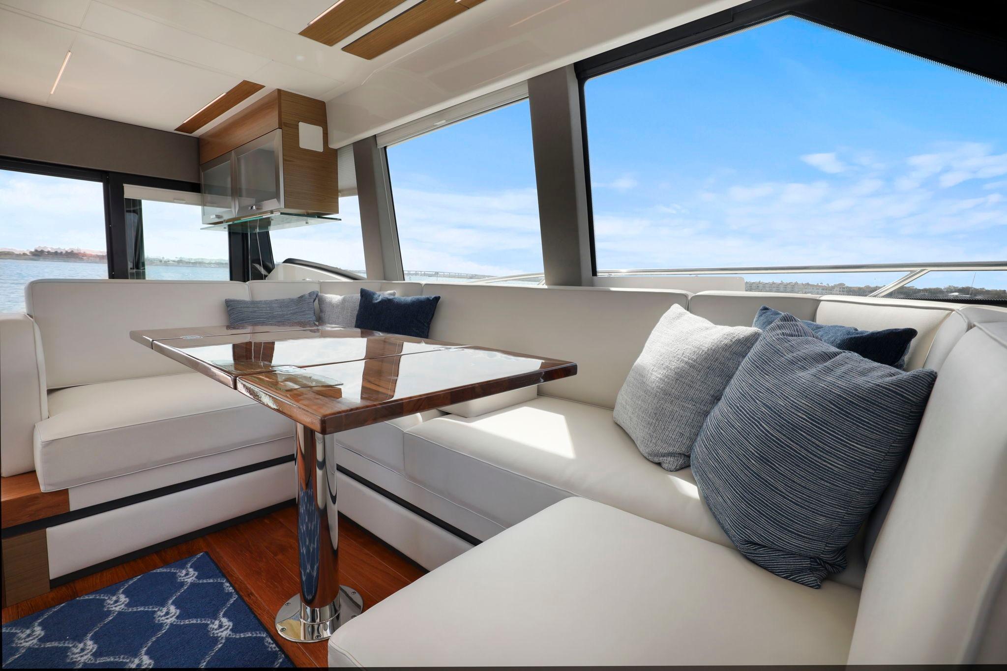 Luxurious interior of 2023 Tiara Yachts C49 Coupe with elegant seating and scenic views.