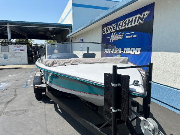 1992 Correct Craft Ski Nautique boat on trailer outside a dealership.