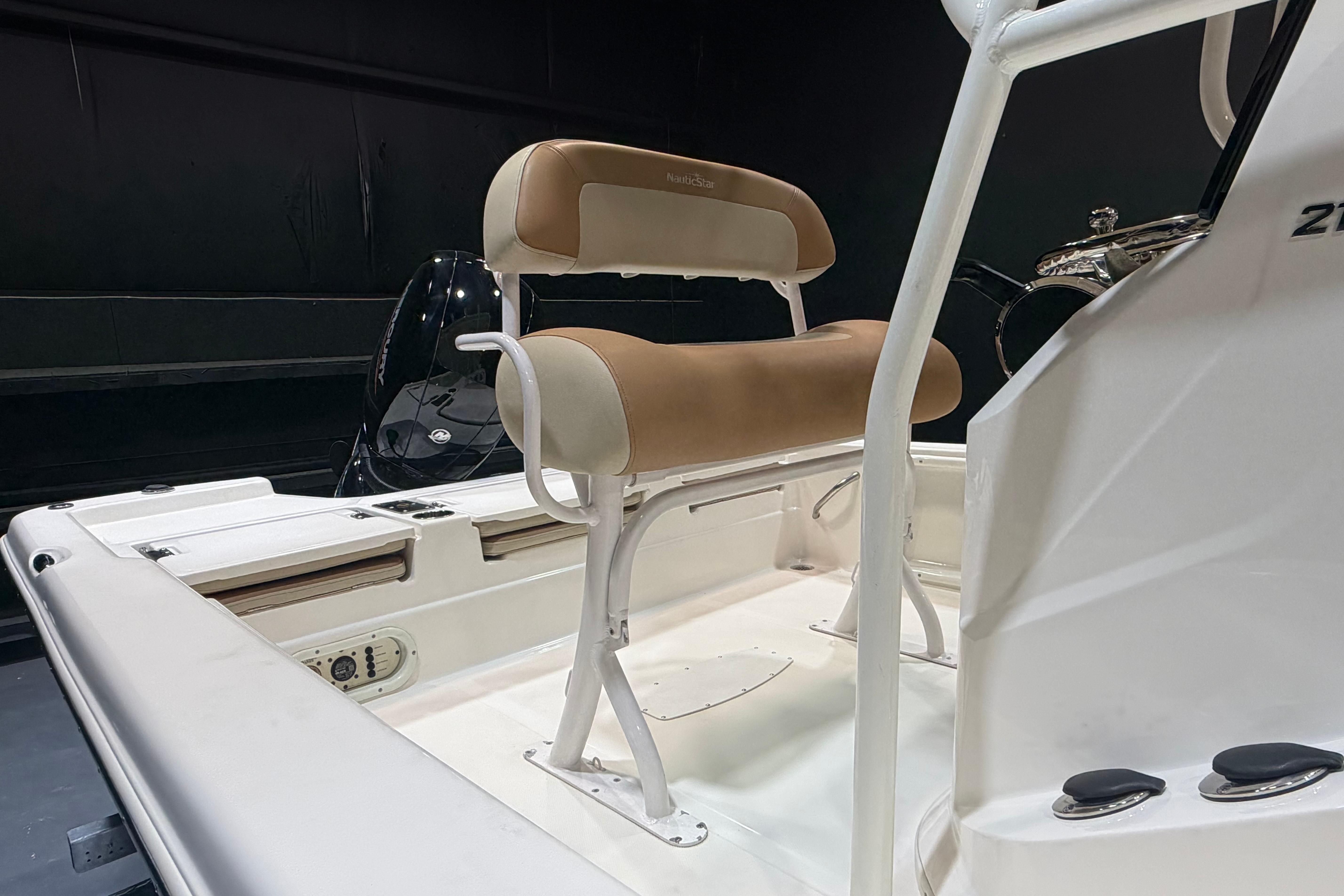 2023 NauticStar 215 XTS boat interior with tan seating and steering console.